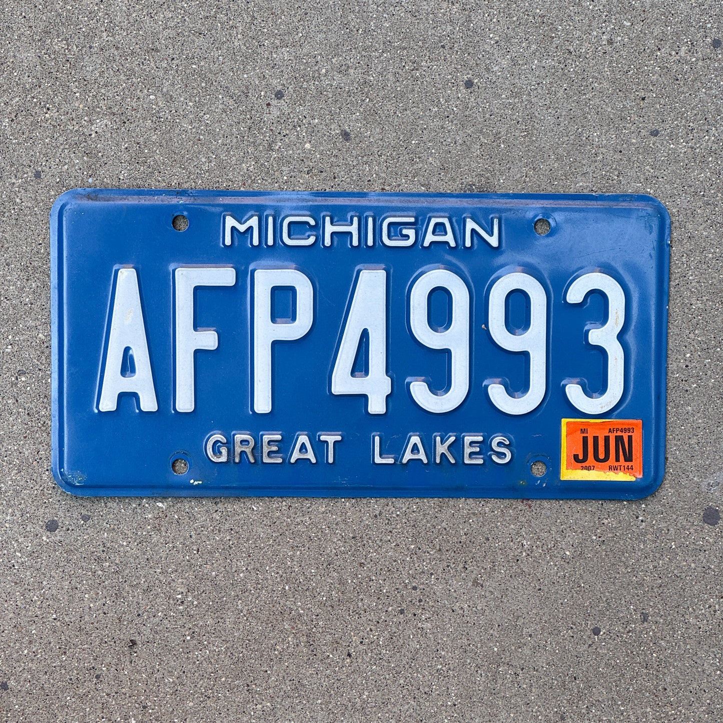 Photo of a 1984 2007 Michigan License Plate Auto Tag Garage Decor Vintage AFP 4993 with original patina