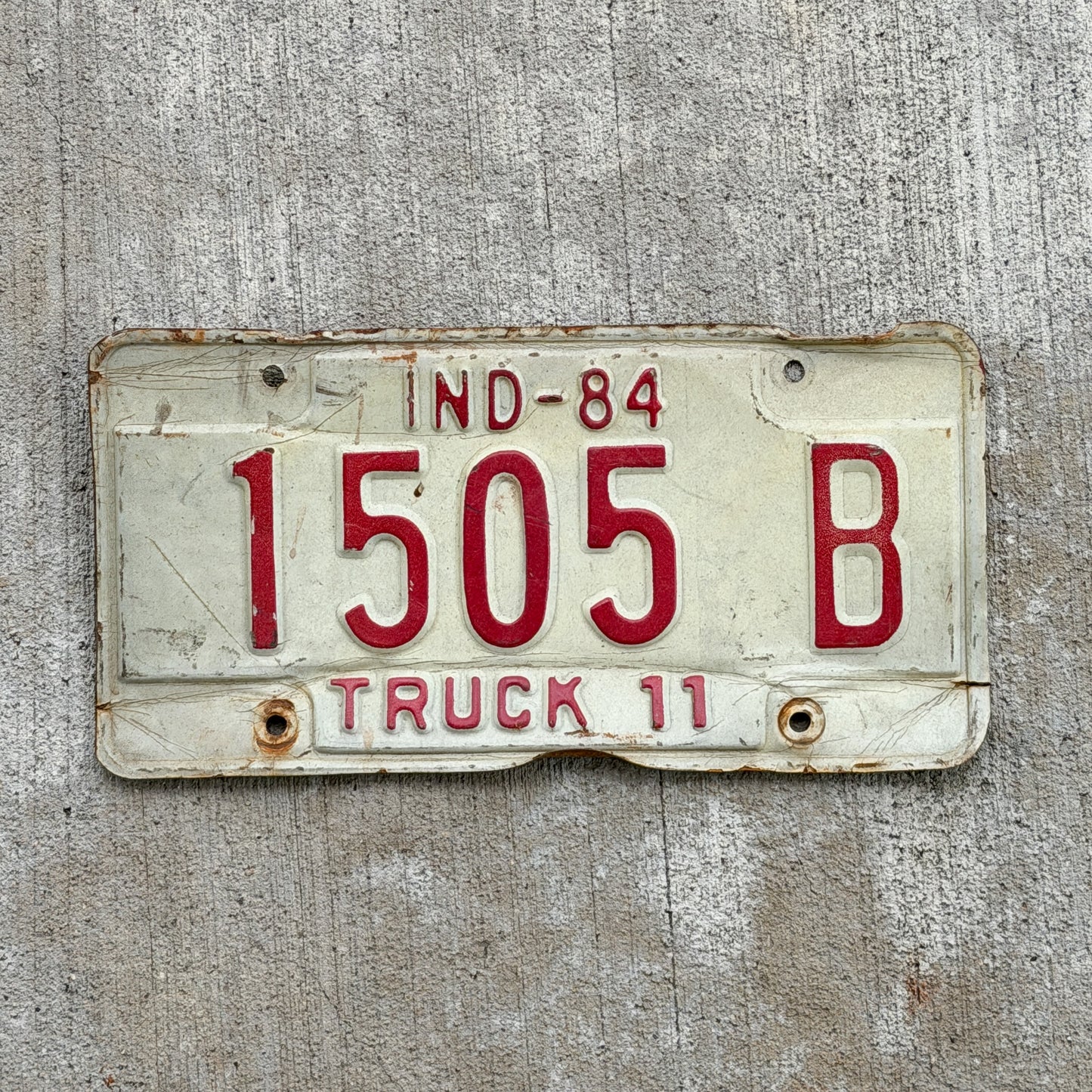 Photo of a 1984 Indiana Truck License Plate Auto Tag Garage Decor Vintage 1505 B with original patina