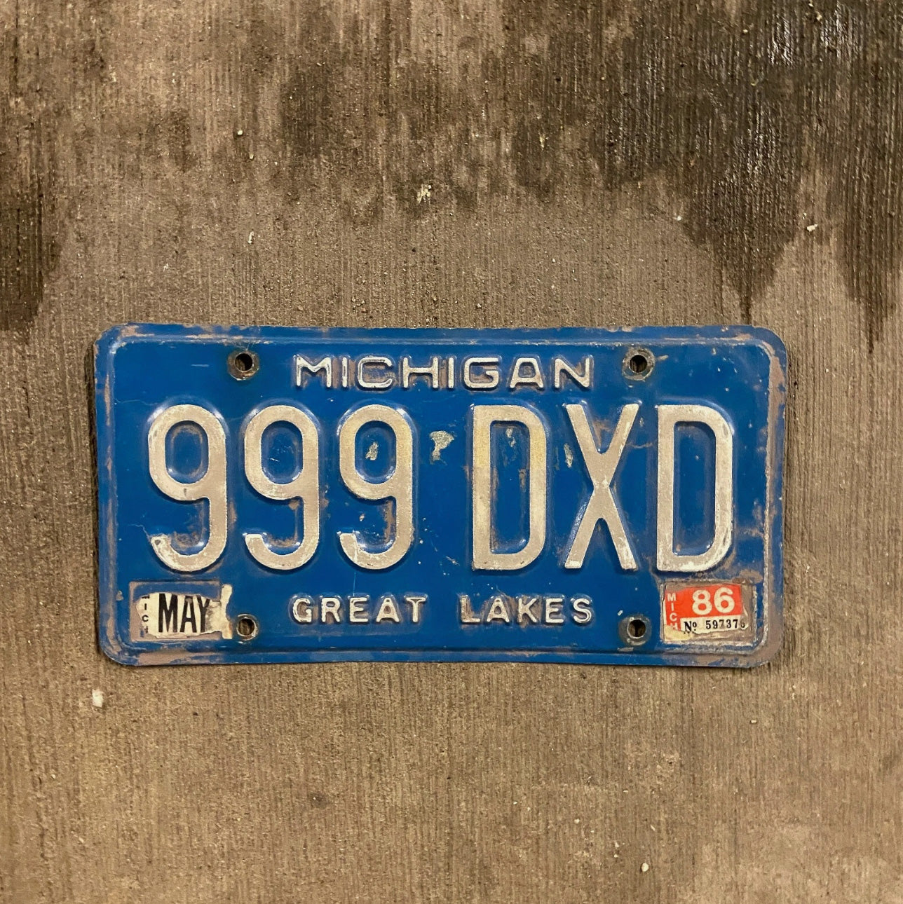Photo of a 1984 Michigan License Plate Auto Tag Garage Decor Vintage Repeat Repeating Blue 999 DXD