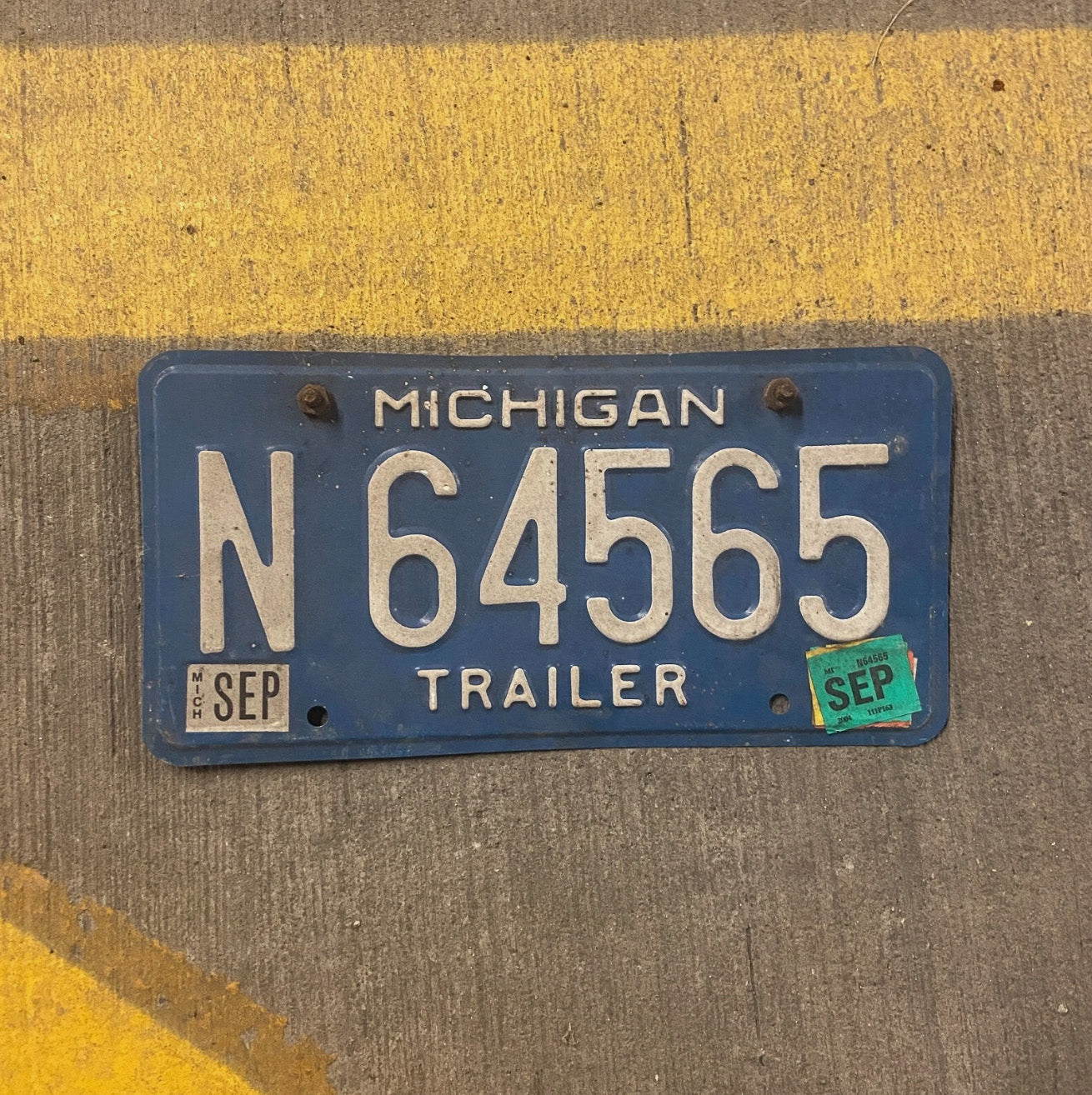 Photo of a 1984 Michigan Trailer License Plate Auto Tag Garage Decor Vintage N 64565