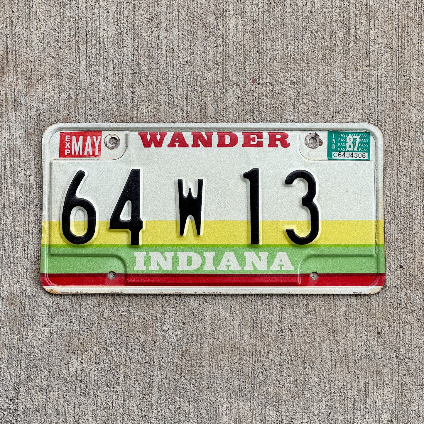 Photo of a 1985 1987 Indiana License Plate Auto Tag Garage Decor Vintage Porter County Low Number 64 W 13 with original patina