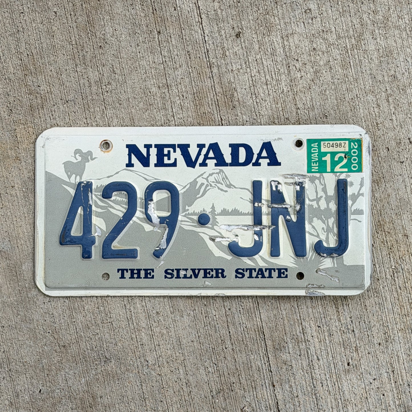Photo of a 1985 2000 Nevada License Plate Auto Tag Garage Decor Vintage 429 JNJ with original patina