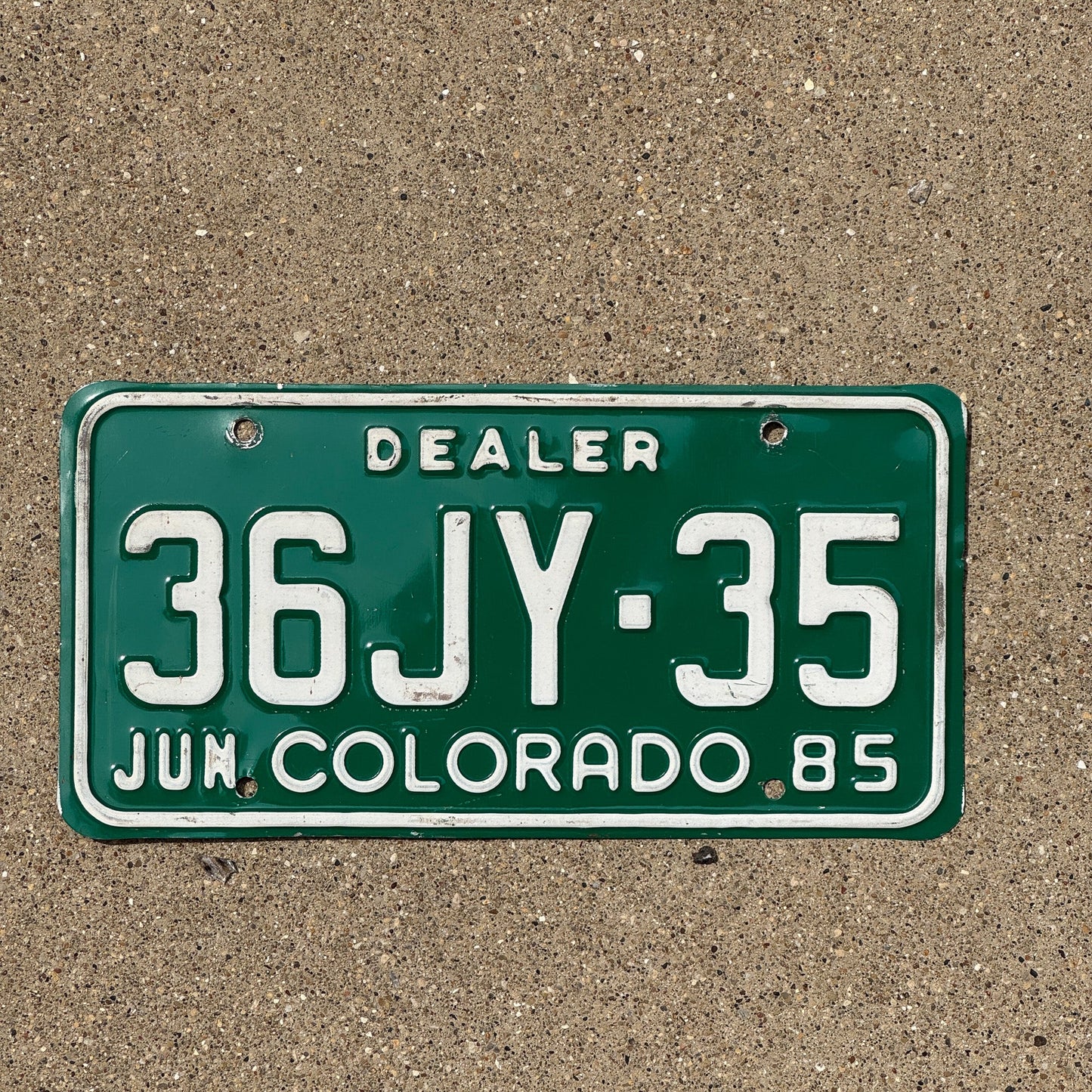 Photo of a 1985 Colorado Dealer License Plate Auto Tag Garage Decor Vintage 36JY 35