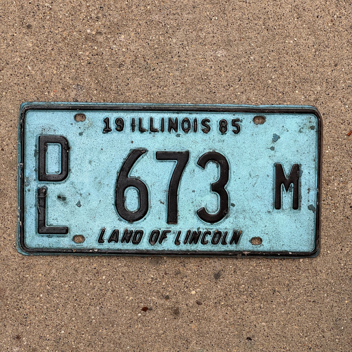 Photo of a 1985 Illinois Dealer License Plate Auto Tag 1 Vintage Garage Merritt's Sterling Ford Mercury Lincoln Dealer 673 M with original patina