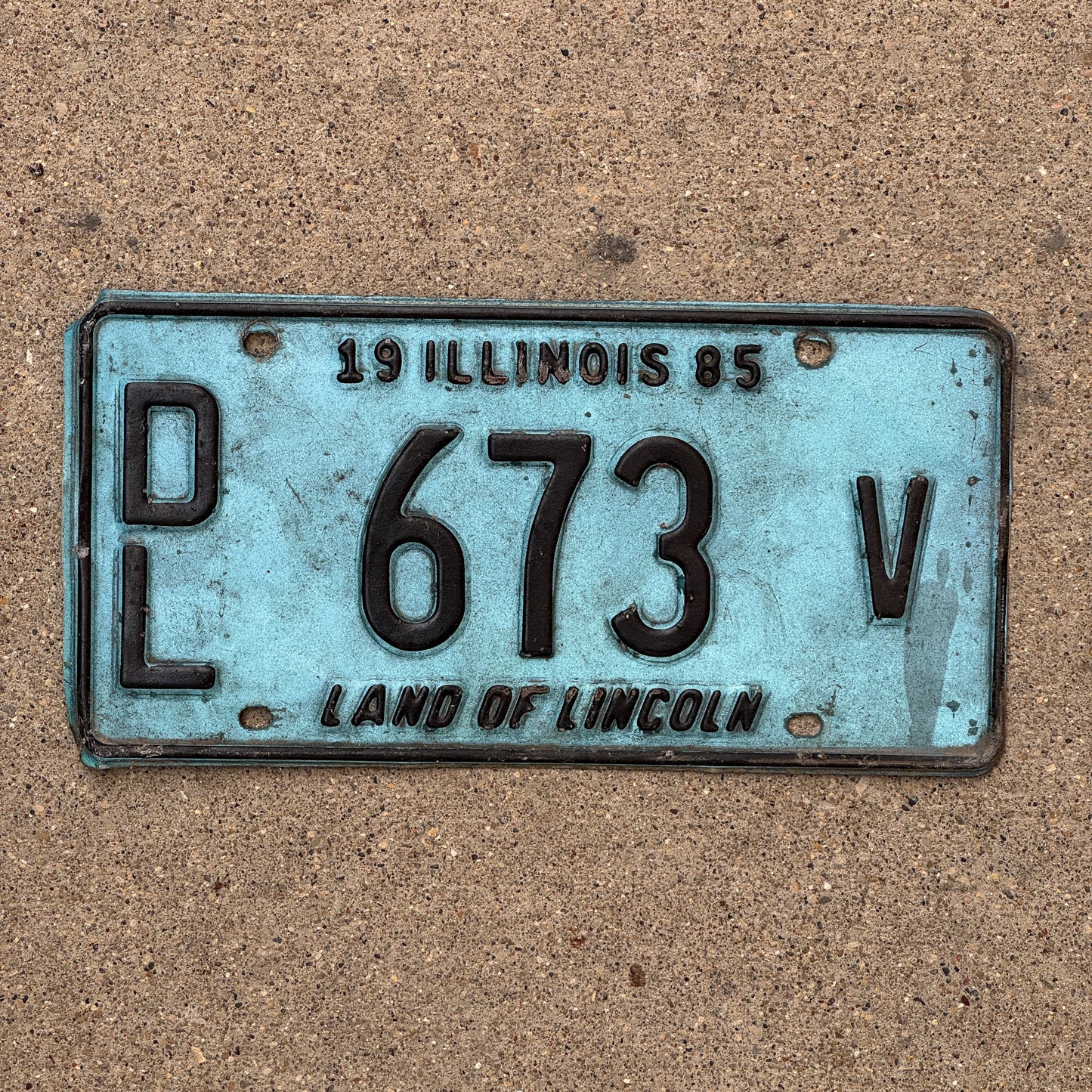 Photo of a 1985 Illinois Dealer License Plate Auto Tag 1 Vintage Garage Merritt's Sterling Ford Mercury Lincoln Dealer 673 V with original patina