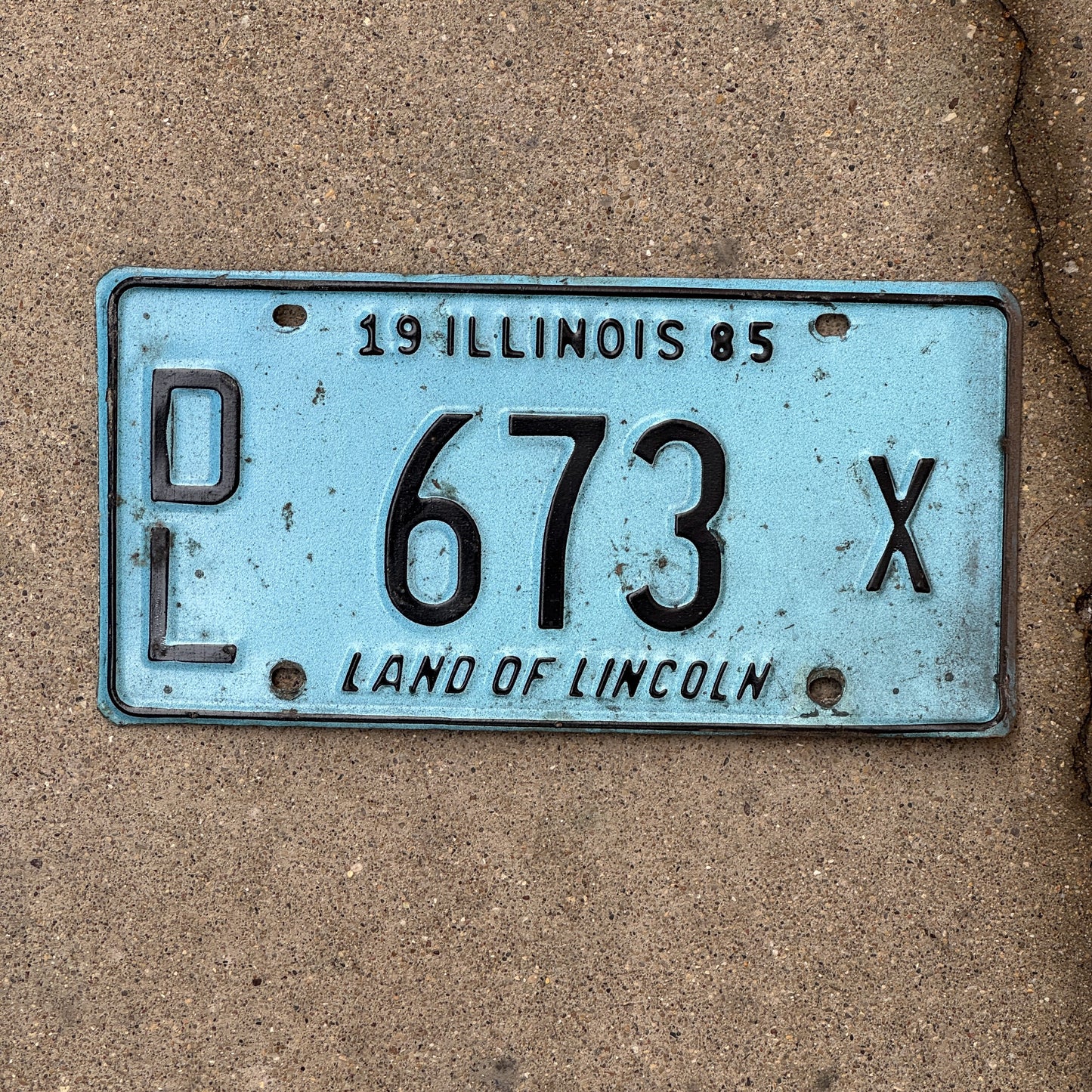 Photo of a 1985 Illinois Dealer License Plate Auto Tag 1 Vintage Garage Merritt's Sterling Ford Mercury Lincoln Dealer 673 X with original patina