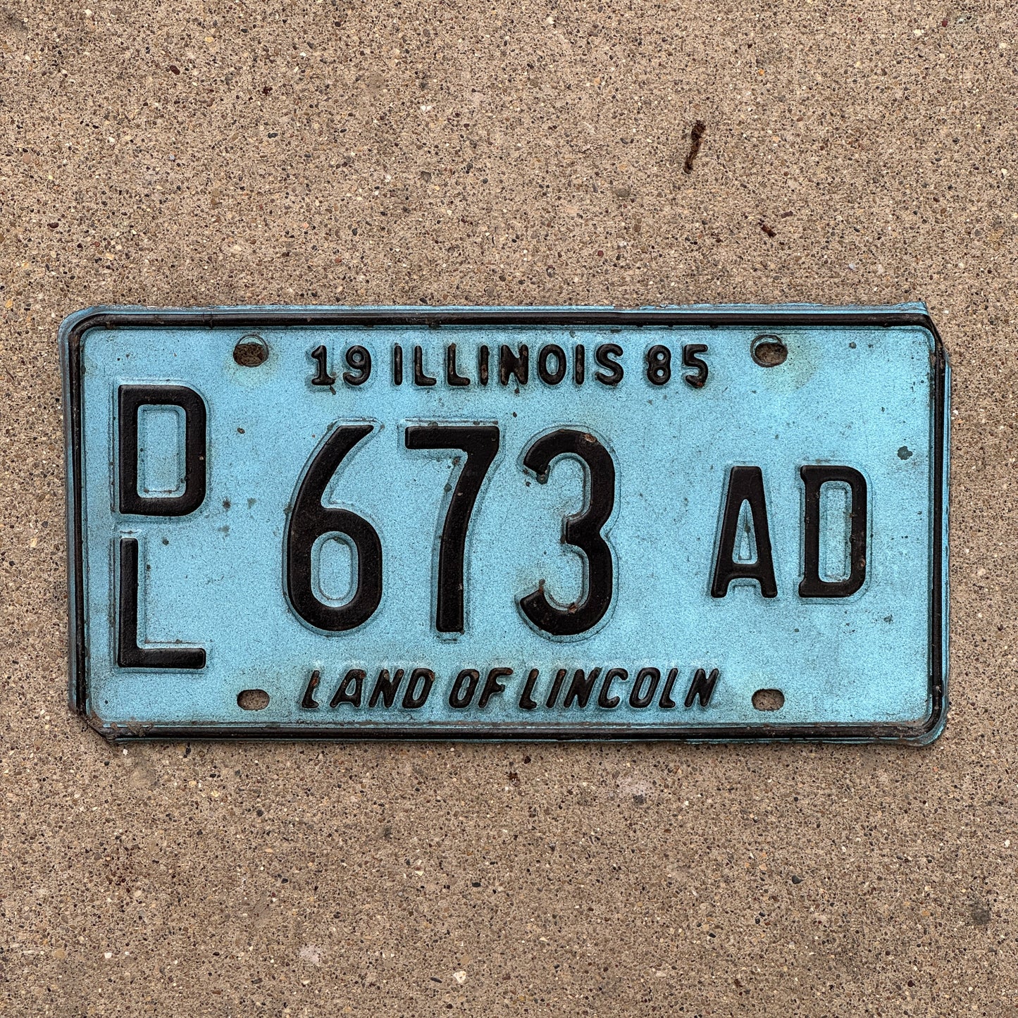 Photo of a 1985 Illinois Dealer License Plate Auto Tag 2 Vintage Garage Merritt's Sterling Ford Mercury Lincoln Dealer 673 AD with original patina