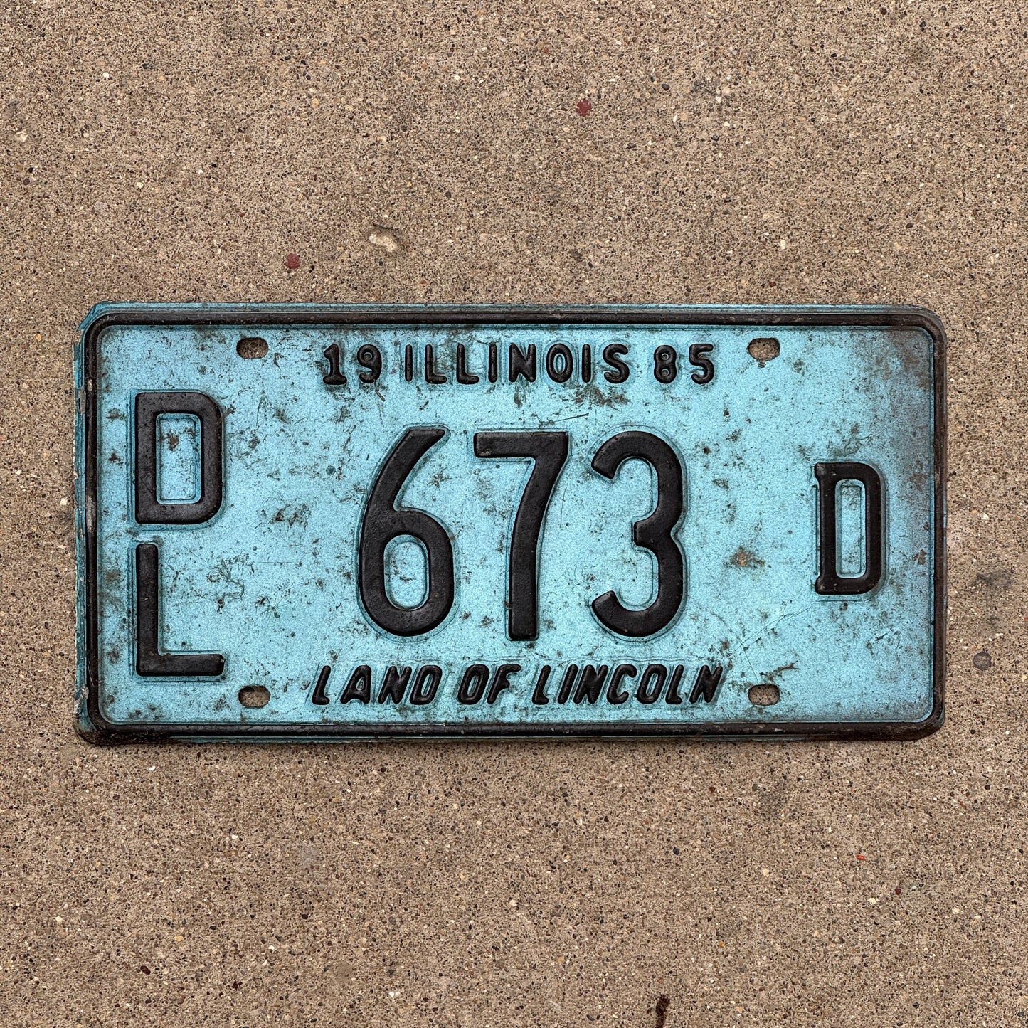 Photo of a 1985 Illinois Dealer License Plate Auto Tag 2 Vintage Garage Merritt's Sterling Ford Mercury Lincoln Dealer 673 D with original patina