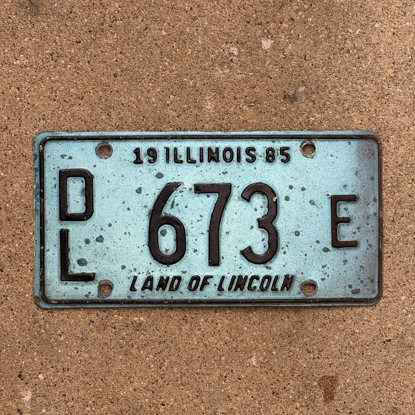 Photo of a 1985 Illinois Dealer License Plate Auto Tag 2 Vintage Garage Merritt's Sterling Ford Mercury Lincoln Dealer 673 E with original patina