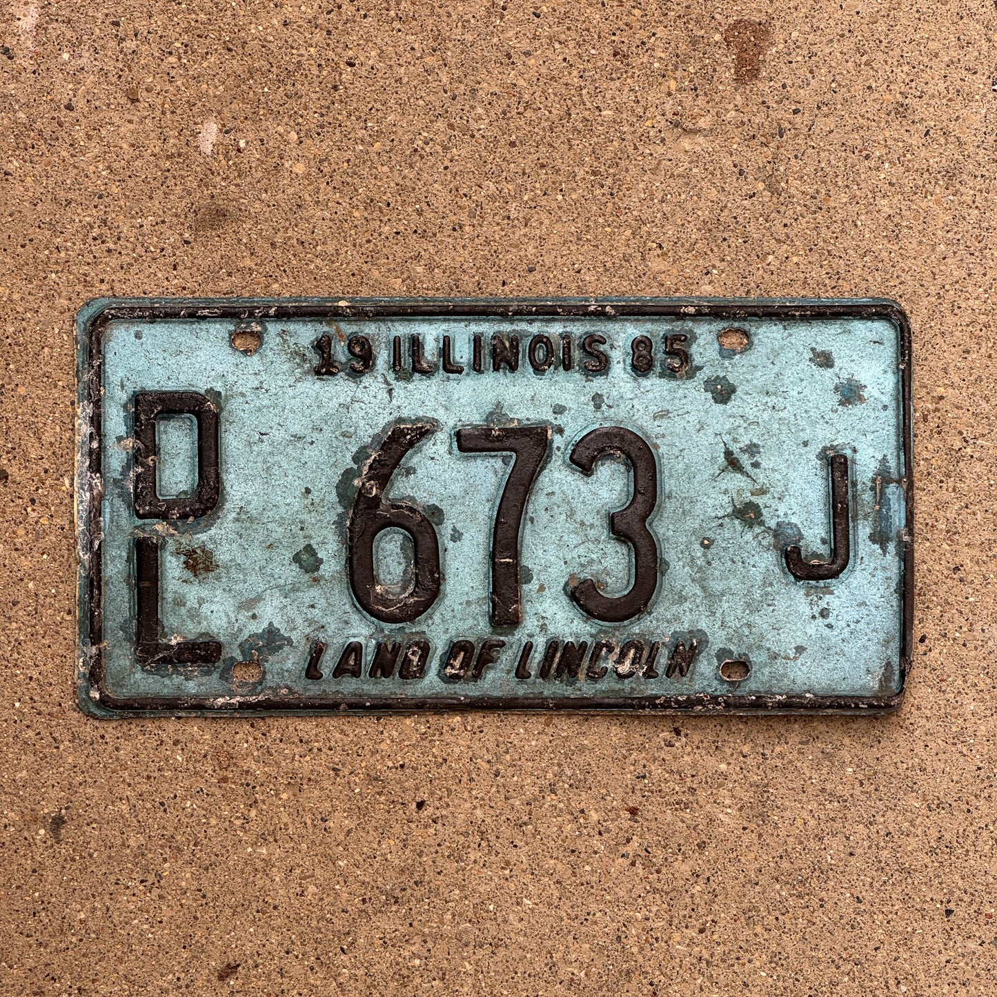 Photo of a 1985 Illinois Dealer License Plate Auto Tag 2 Vintage Garage Merritt's Sterling Ford Mercury Lincoln Dealer 673 J with original patina