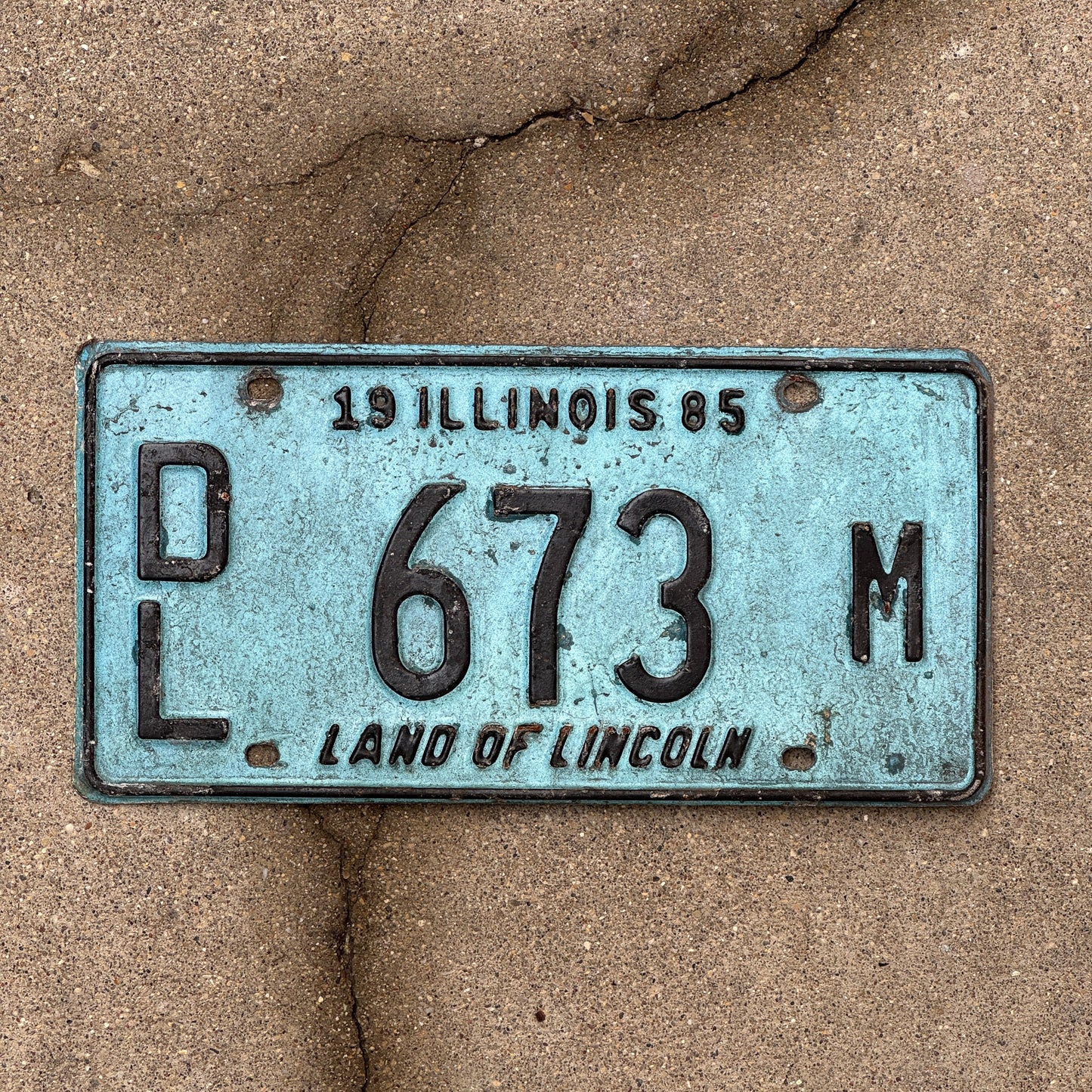 Photo of a 1985 Illinois Dealer License Plate Auto Tag 2 Vintage Garage Merritt's Sterling Ford Mercury Lincoln Dealer 673 M with original patina