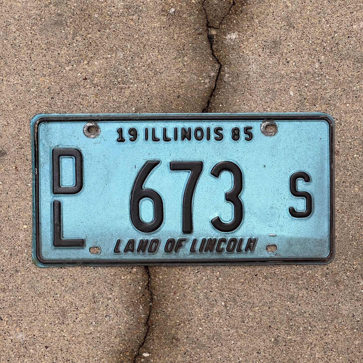 Photo of a 1985 Illinois Dealer License Plate Auto Tag 2 Vintage Garage Merritt's Sterling Ford Mercury Lincoln Dealer 673 S with original patina