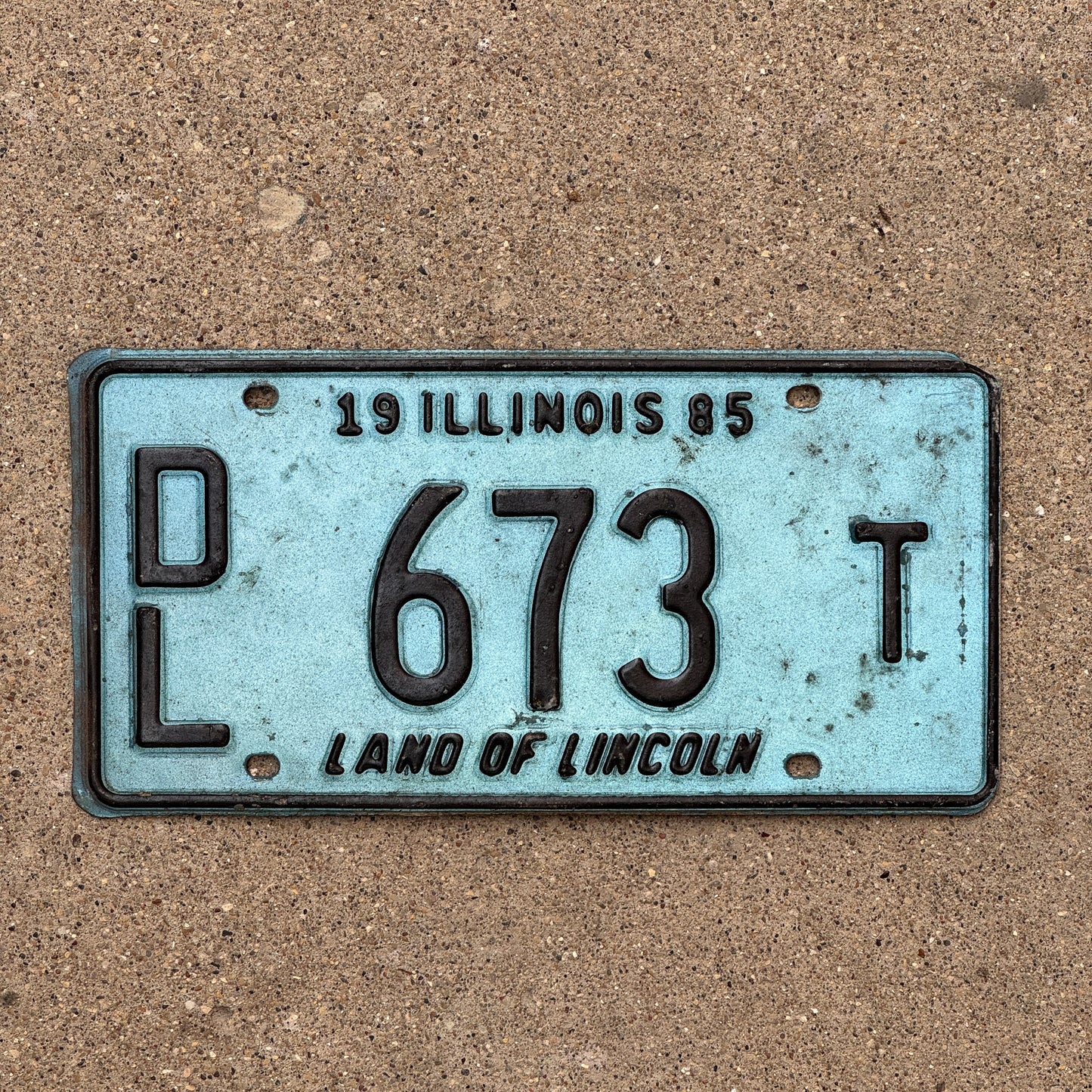Photo of a 1985 Illinois Dealer License Plate Auto Tag 2 Vintage Garage Merritt's Sterling Ford Mercury Lincoln Dealer 673 T with original patina