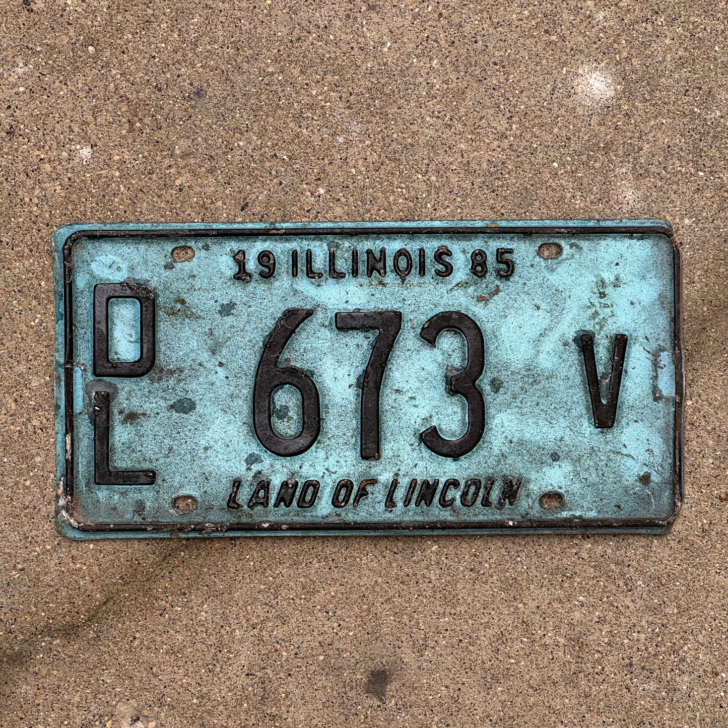 Photo of a 1985 Illinois Dealer License Plate Auto Tag 2 Vintage Garage Merritt's Sterling Ford Mercury Lincoln Dealer 673 V with original patina