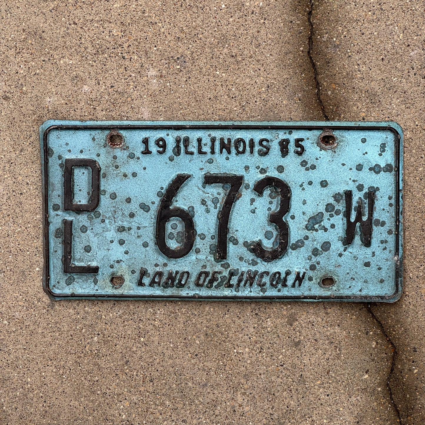 Photo of a 1985 Illinois Dealer License Plate Auto Tag 2 Vintage Garage Merritt's Sterling Ford Mercury Lincoln Dealer 673 W with original patina