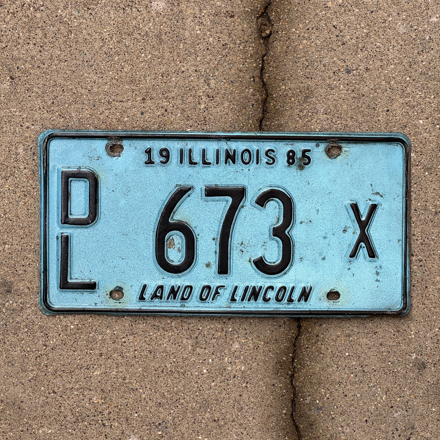Photo of a 1985 Illinois Dealer License Plate Auto Tag 2 Vintage Garage Merritt's Sterling Ford Mercury Lincoln Dealer 673 X with original patina