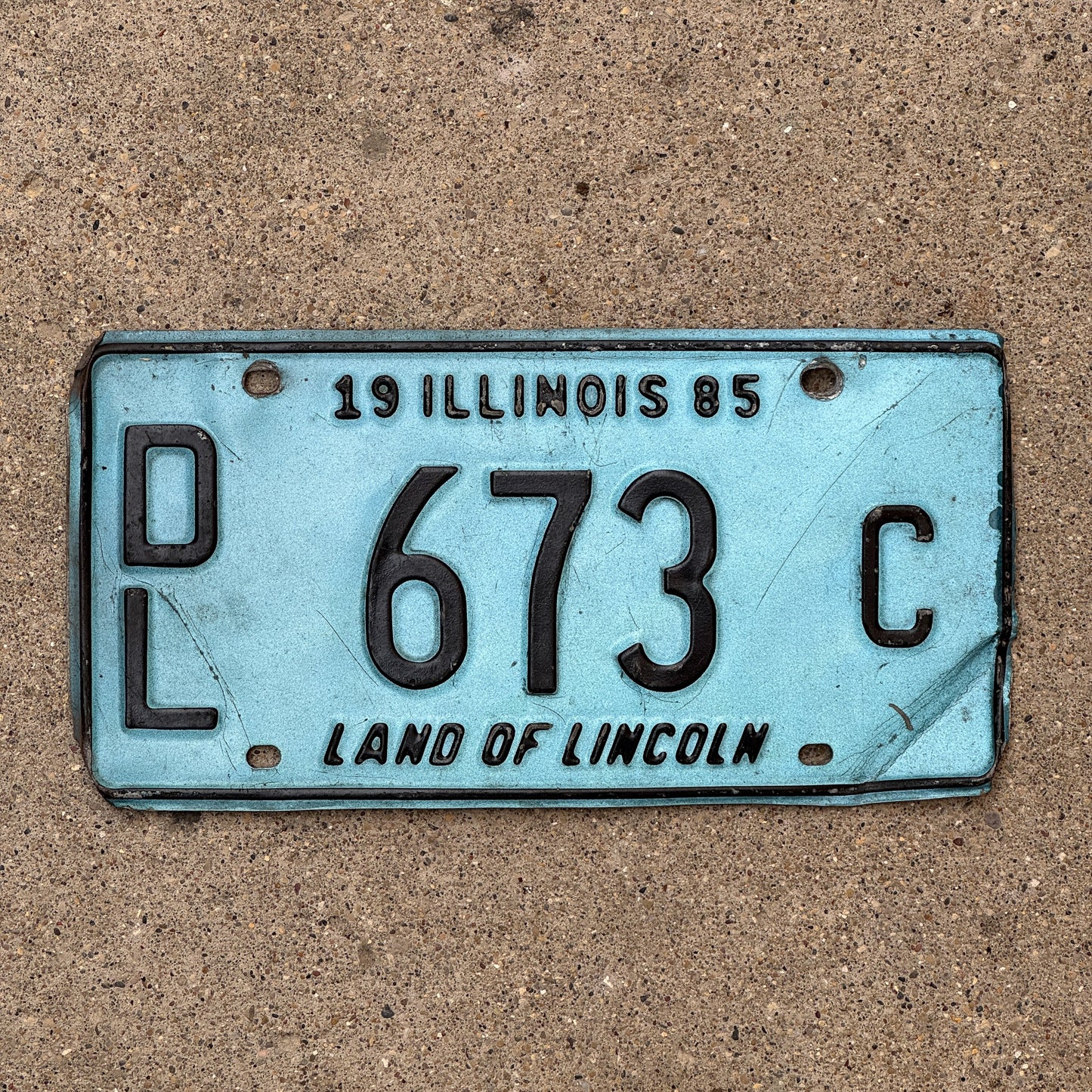 Photo of a 1985 Illinois Dealer License Plate Auto Tag Garage Decor Vintage Merritt's Sterling Ford Mercury Lincoln Dealer 673 C with original patina