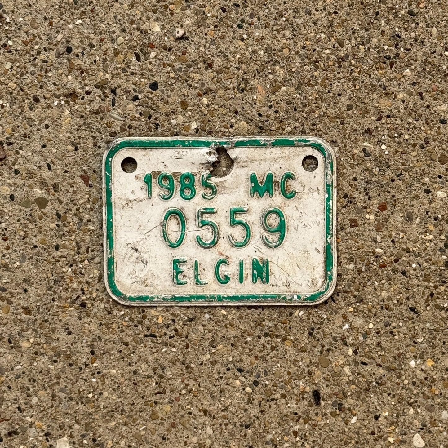 Photo of a 1985 Illinois Motorcycle Tax Tag Auto Tag Garage Decor Vintage Elgin 0559