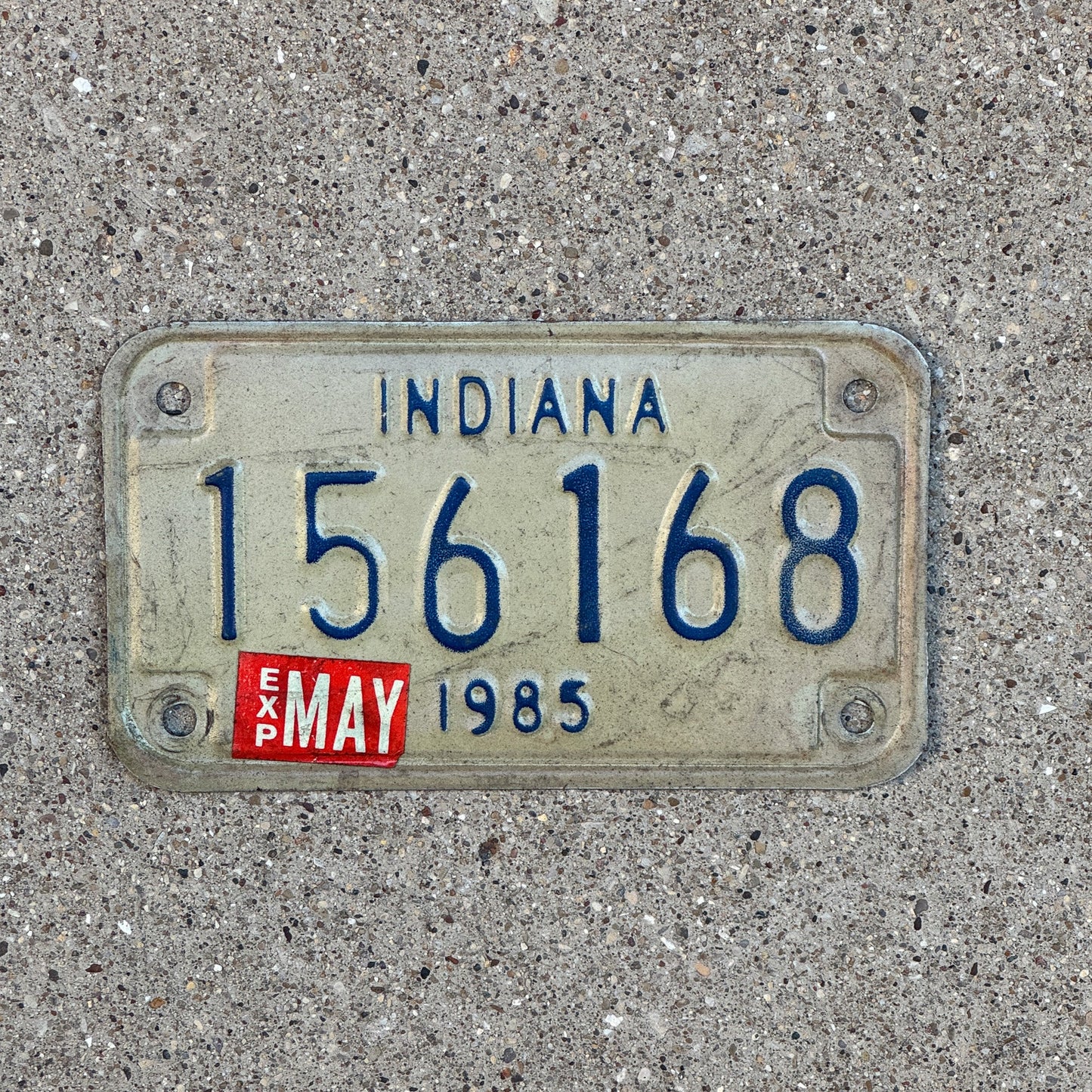 Photo of a 1985 Indiana Motorcycle License Plate Auto Tag Garage Decor Vintage 156168 with original patina