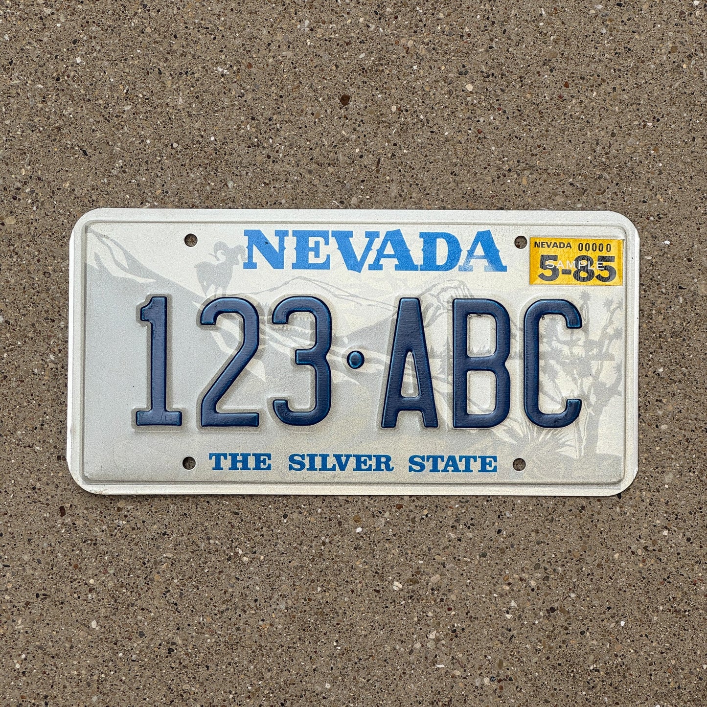 Photo of a 1985 Nevada Sample License Plate Auto Tag Garage Decor Vintage 123 ABC