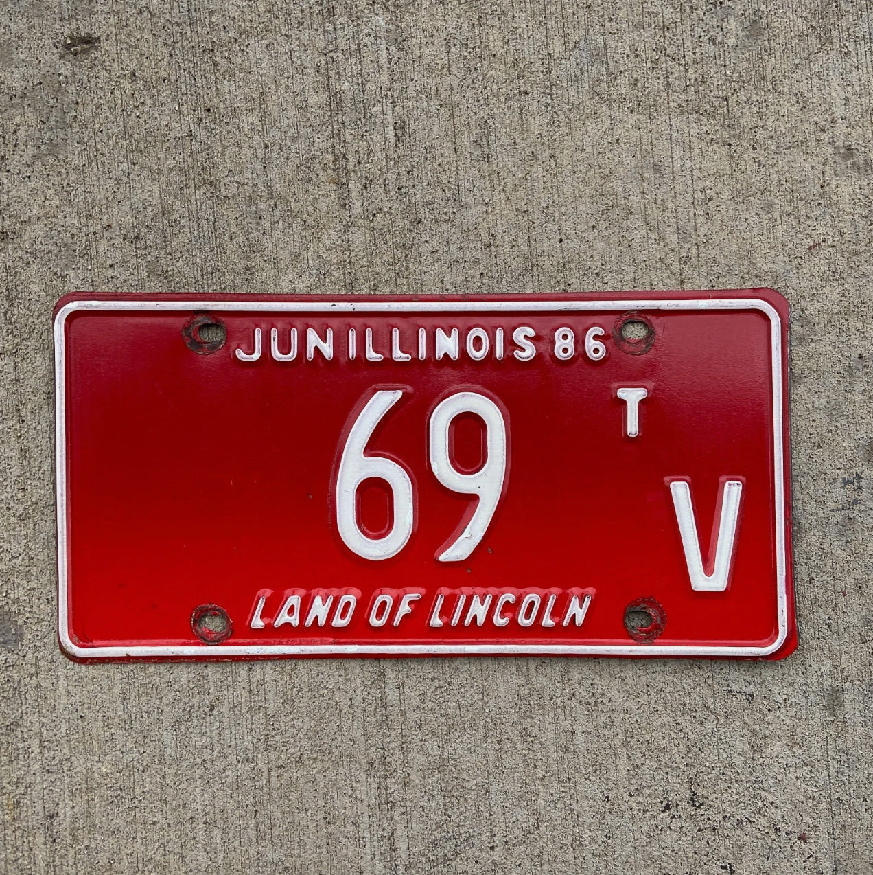 Photo of a 1986 Illinois Truck Tractor License Plate Auto Tag Garage Decor Vintage Low Number Two Digit 69 TV with original patina