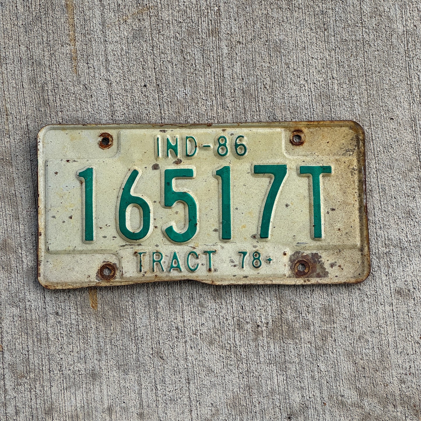 Photo of a 1986 Indiana Tractor License Plate Auto Tag Garage Decor Vintage 16517 T with original patina