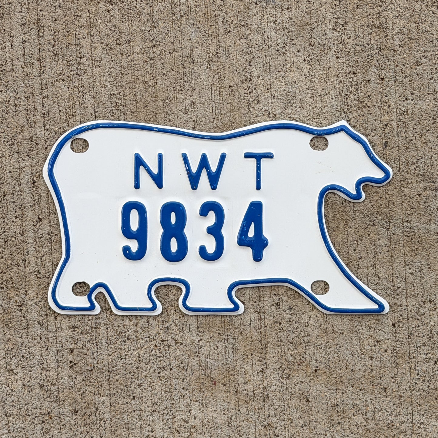Photo of a 1986 Northwest Territories Motorcycle License Plate Auto Tag Garage Decor Vintage Polar Bear 9834 with original patina