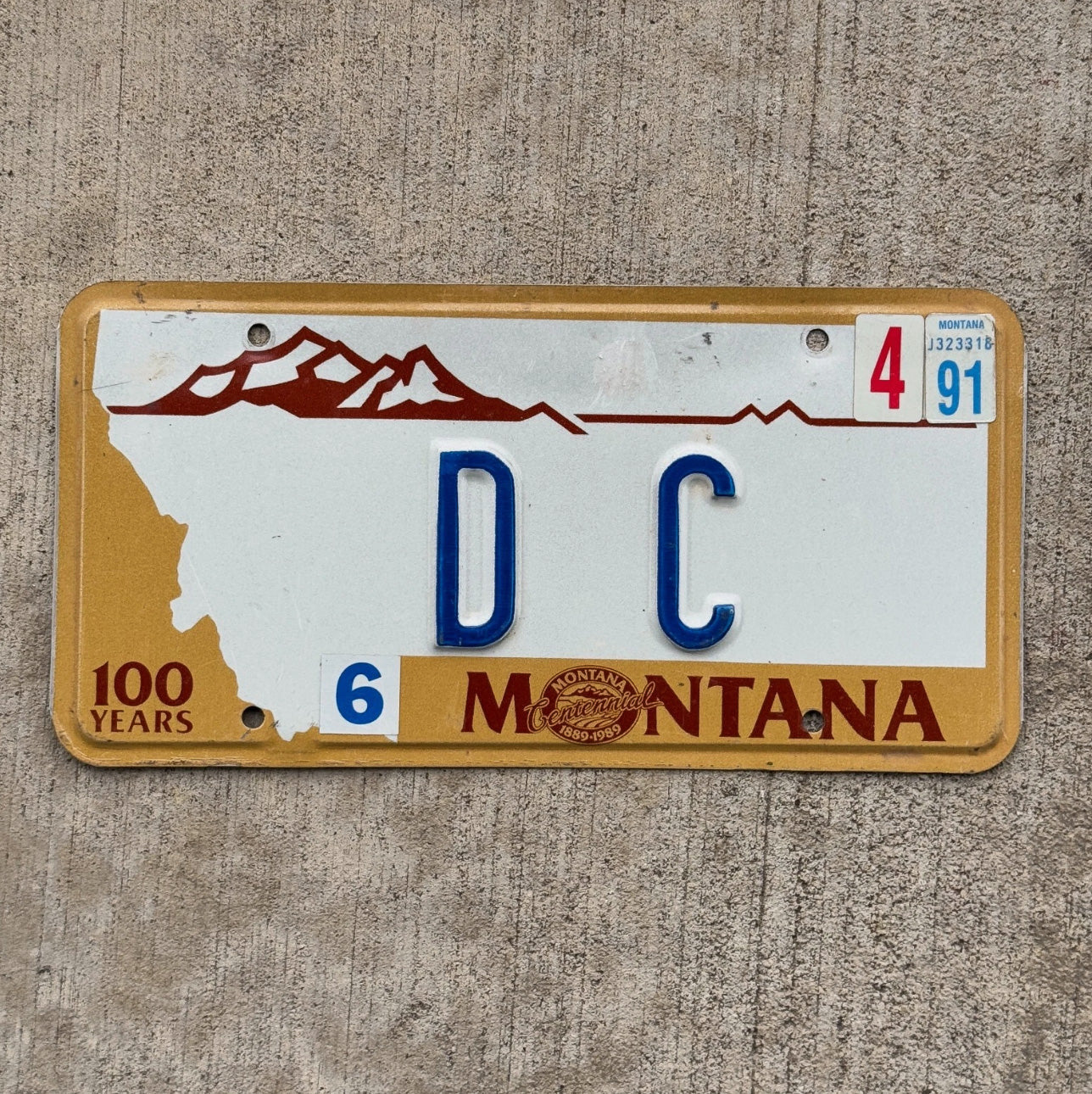 Photo of a 1987 1991 Montana Vanity License Plate Auto Tag Garage Decor Vintage Comic Washington DC
