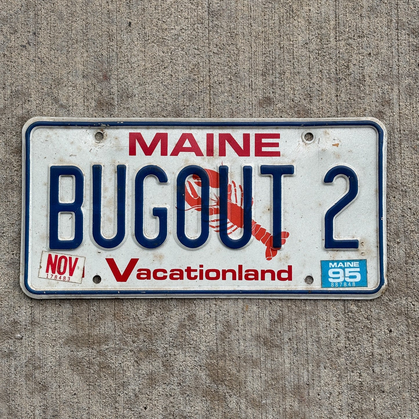 Photo of a 1987 1995 Maine Vanity License Plate Auto Tag Garage Decor Vintage Lobster Base Retreat Military BUGOUT 2 with original patina