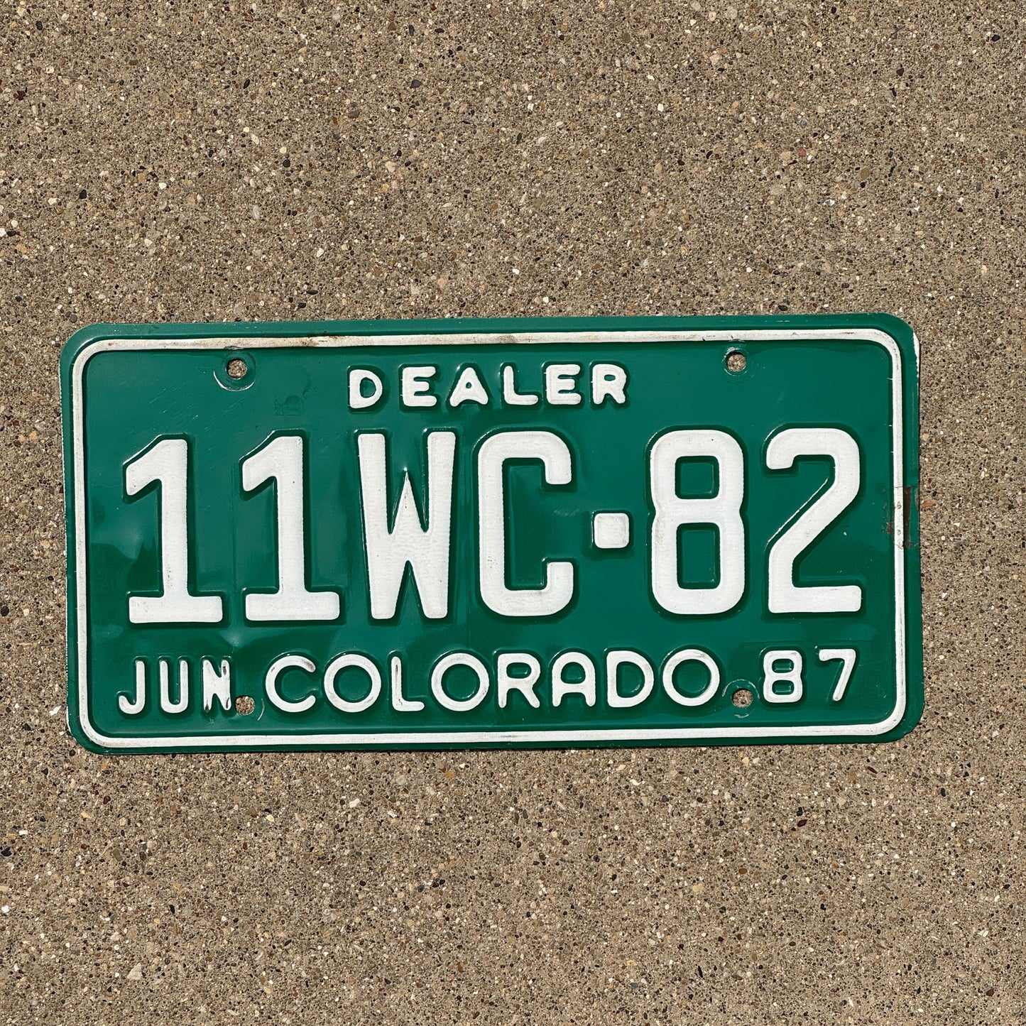 Photo of a 1987 Colorado Dealer License Plate Auto Tag Garage Decor Vintage 11 WC 82