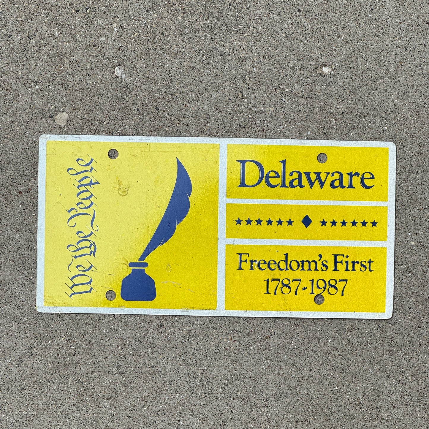 Photo of a 1987 Delaware Booster License Plate Auto Tag Garage Decor Vintage We the People Bicentennial