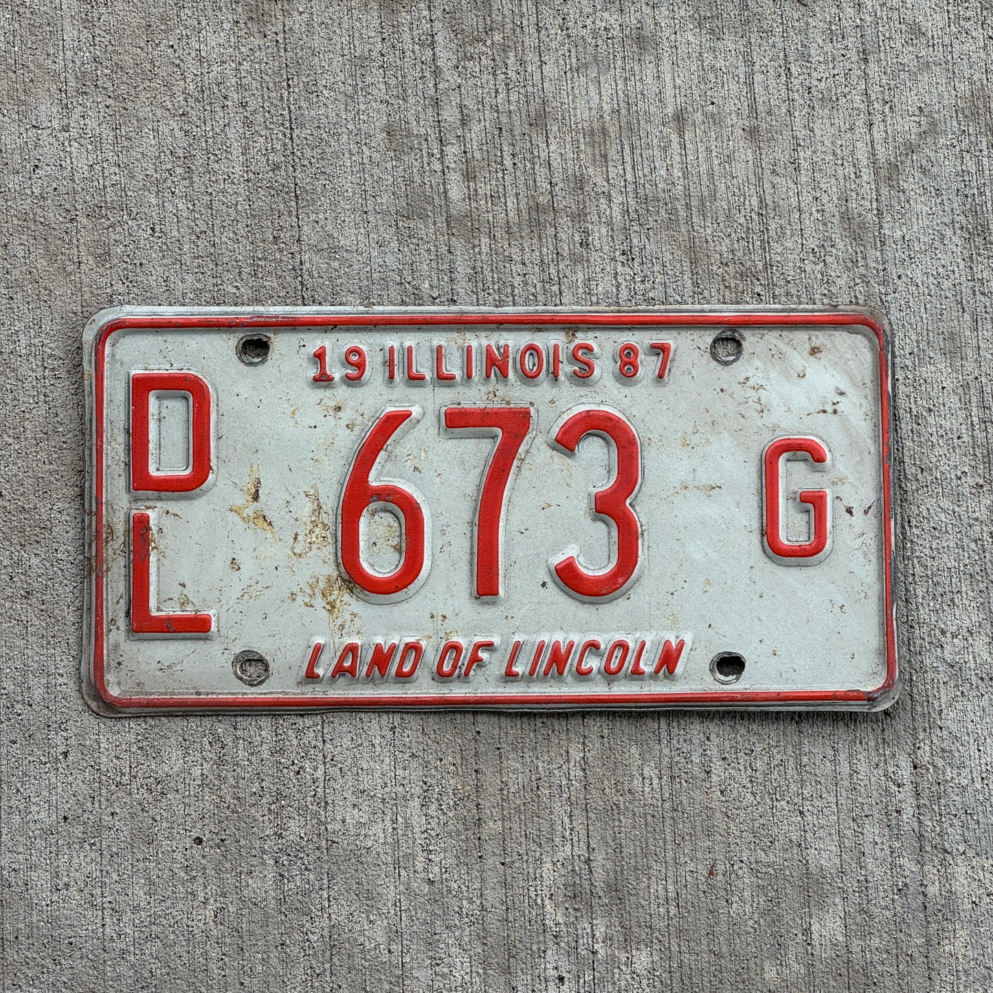 Photo of a 1987 Illinois Dealer License Plate Auto Tag 2 Vintage Garage Merritt's Sterling Ford Mercury Lincoln Dealer 673 G with original patina