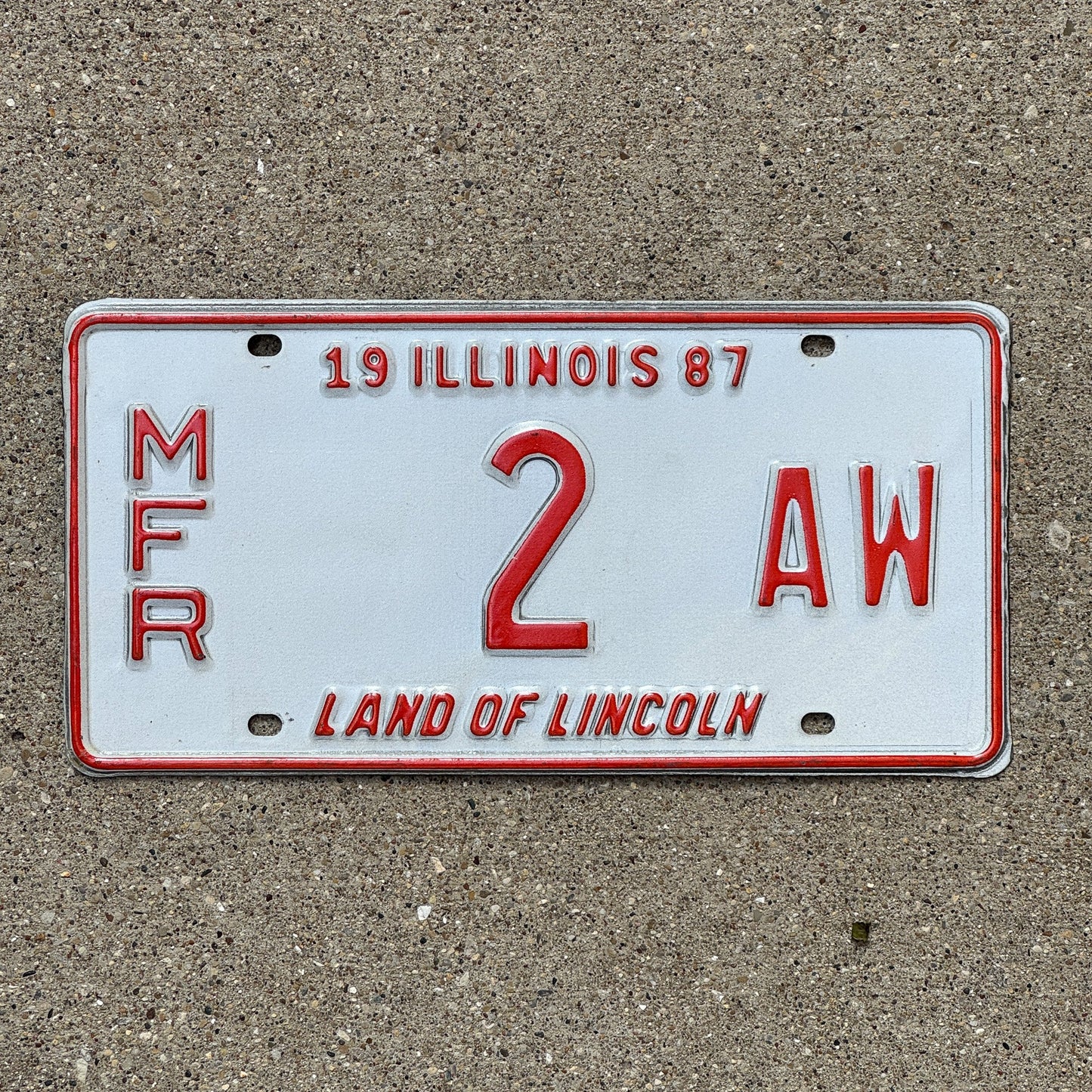 Photo of a 1987 Illinois MANUFACTURER License Plate Auto Tag Garage Decor Vintage 2 AW