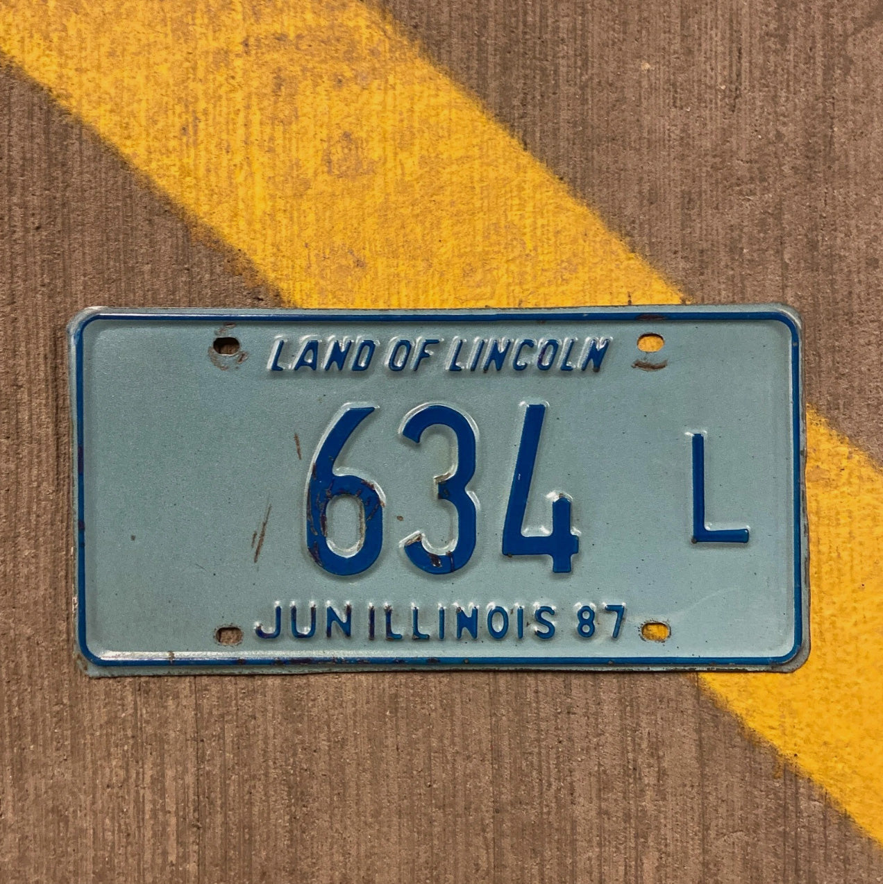 Photo of a 1987 Illinois Truck License Plate Auto Tag Garage Decor Vintage 634 L with original patina