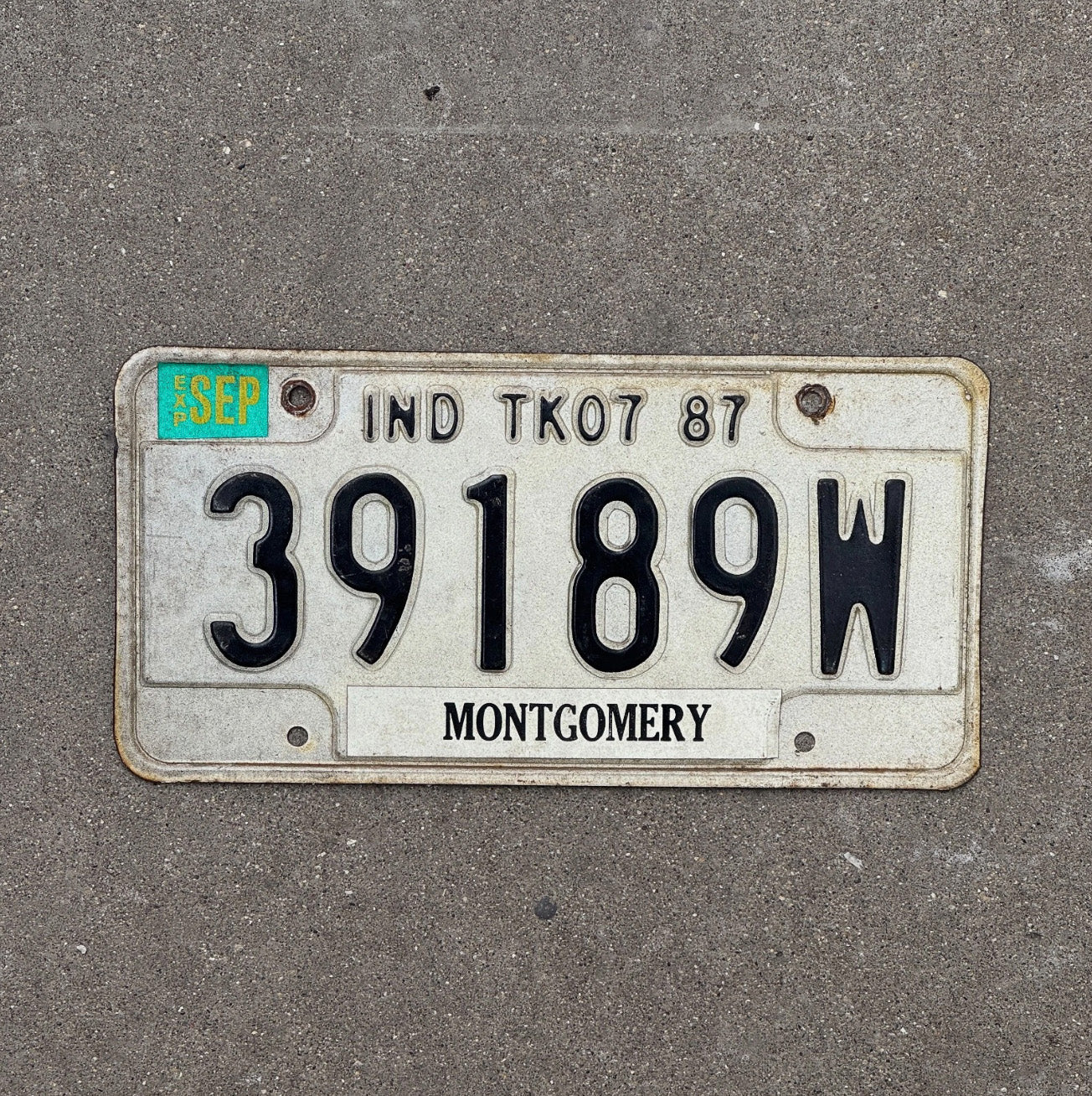 Photo of a 1987 Indiana Truck License Plate Auto Tag Garage Decor 39189 W