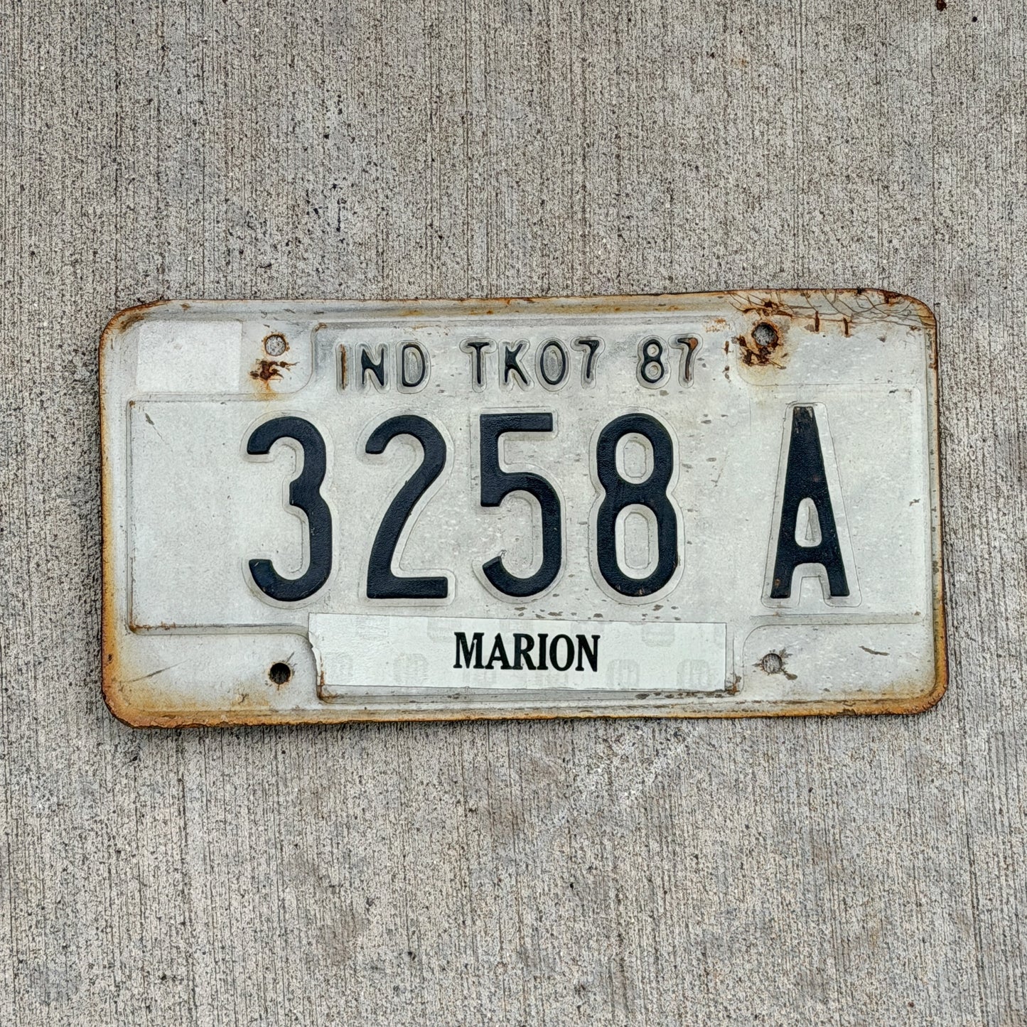 Photo of a 1987 Indiana Truck License Plate Auto Tag Garage Decor Vintage 3258 A with original patina