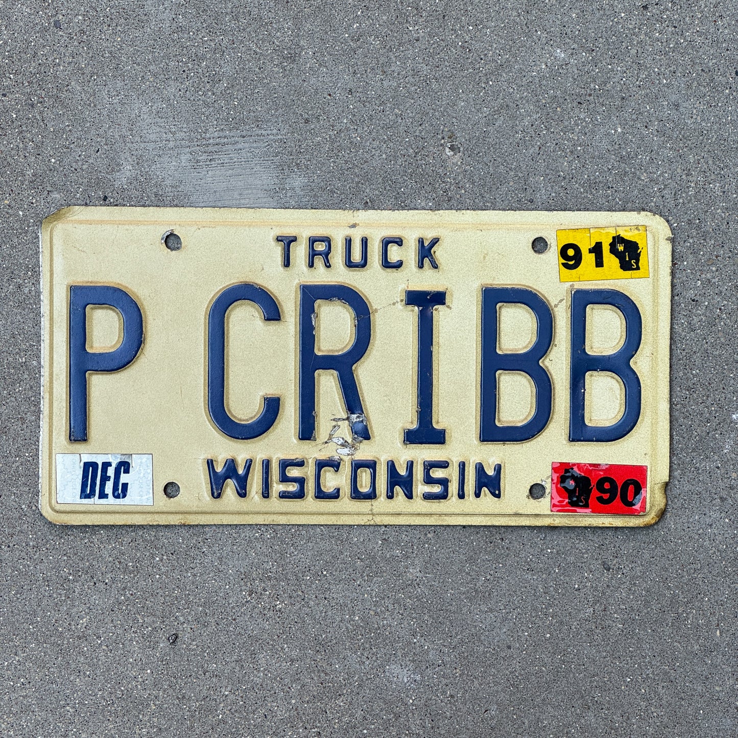 Photo of a 1988 1991 Wisconsin Vanity Truck License Plate Auto Tag Garage Decor Vintage P CRIBB with original patina