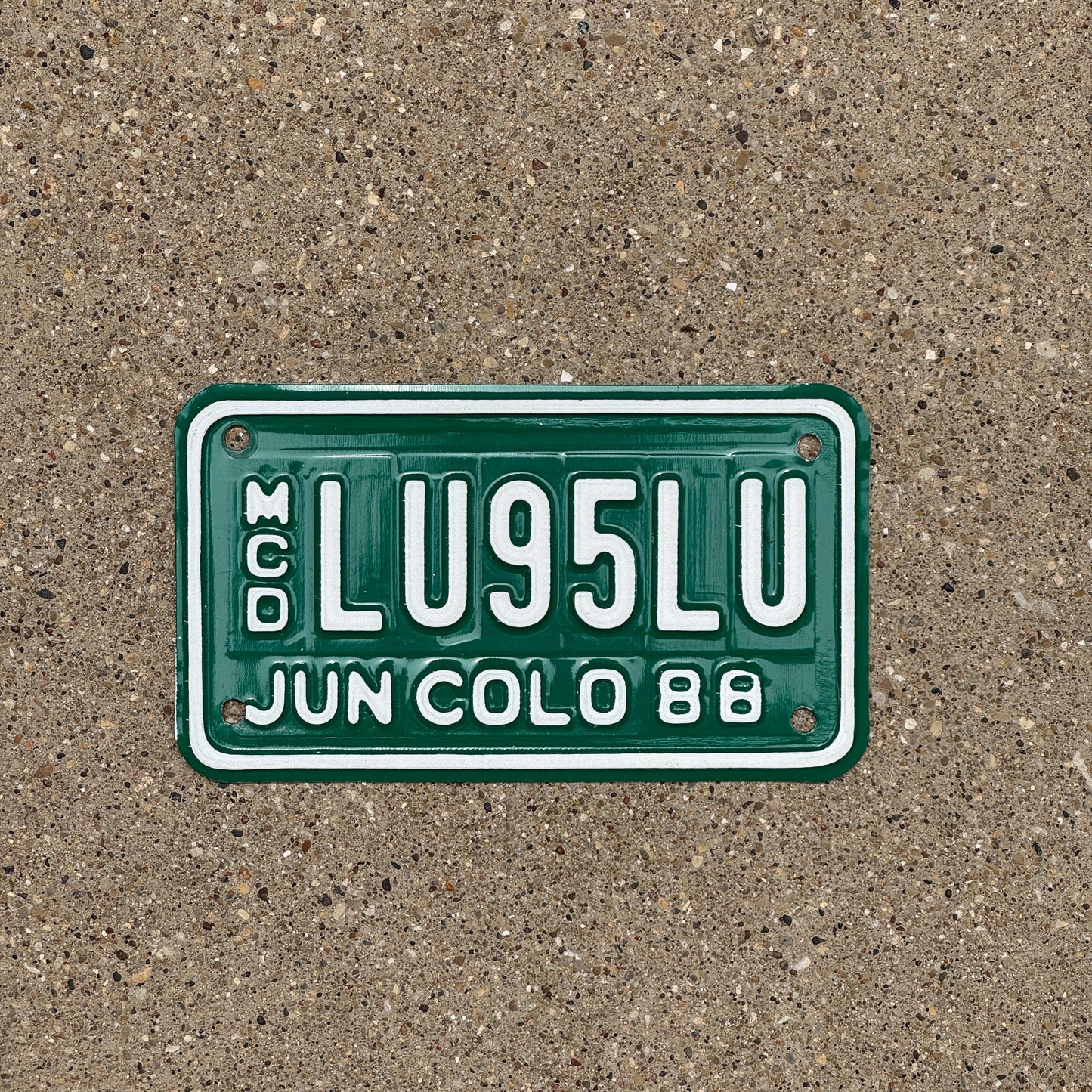 Photo of a 1988 Colorado Motorcycle Dealer License Plate Auto Tag Garage Decor Vintage LU 95 LU