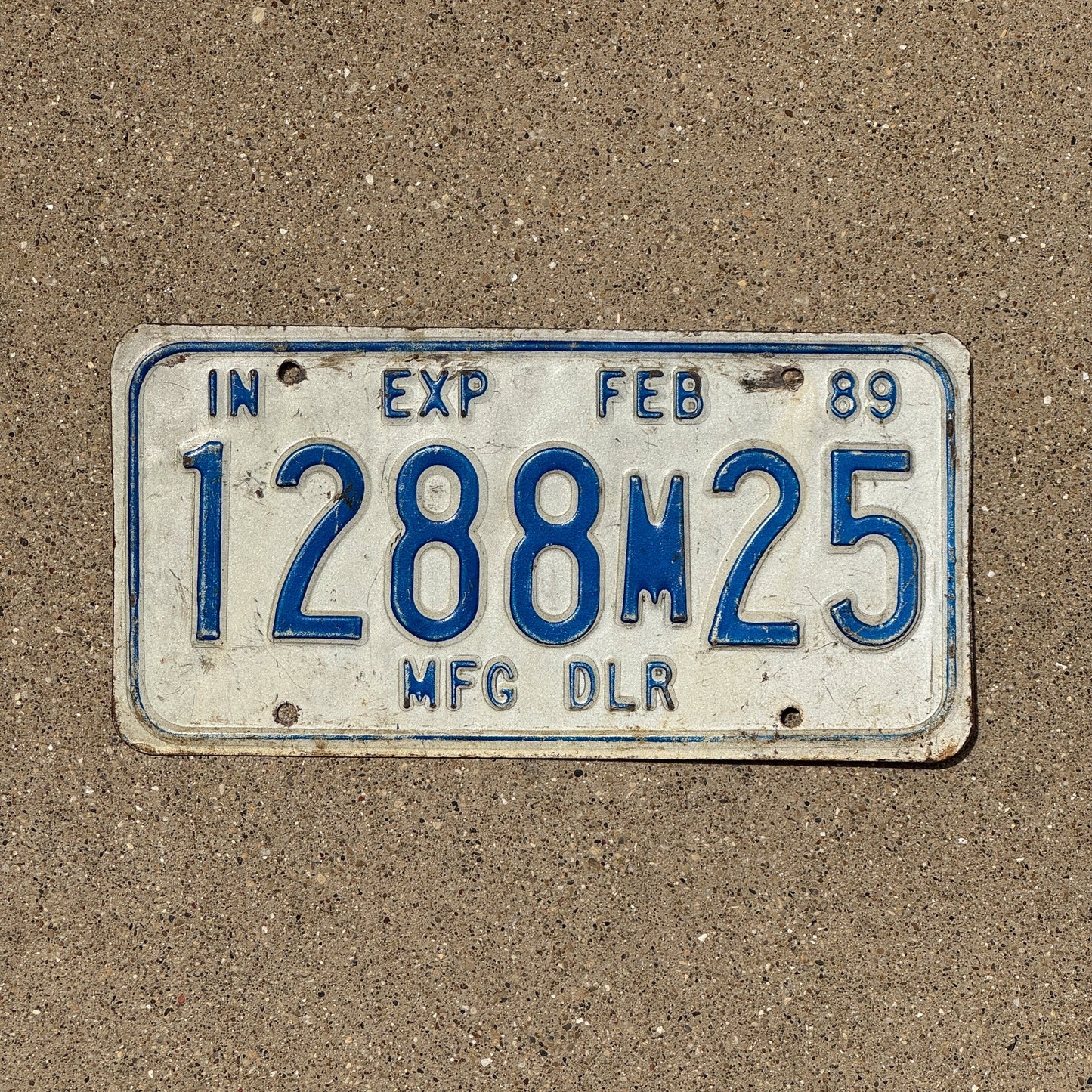 Photo of a 1989 Indiana Manufacture Dealer License Plate Auto Tag Garage Decor Vintage 1288 M 25