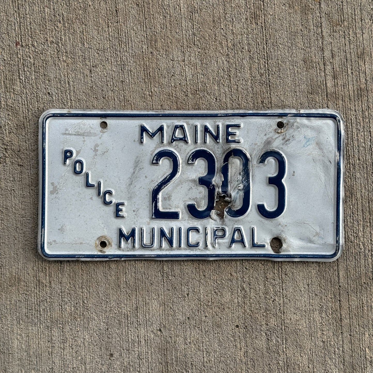 Photo of a 1989 Maine Police License Plate Auto Tag Garage Decor Vintage Type 2 Narrow Dies Wide State Name 2303 with original patina