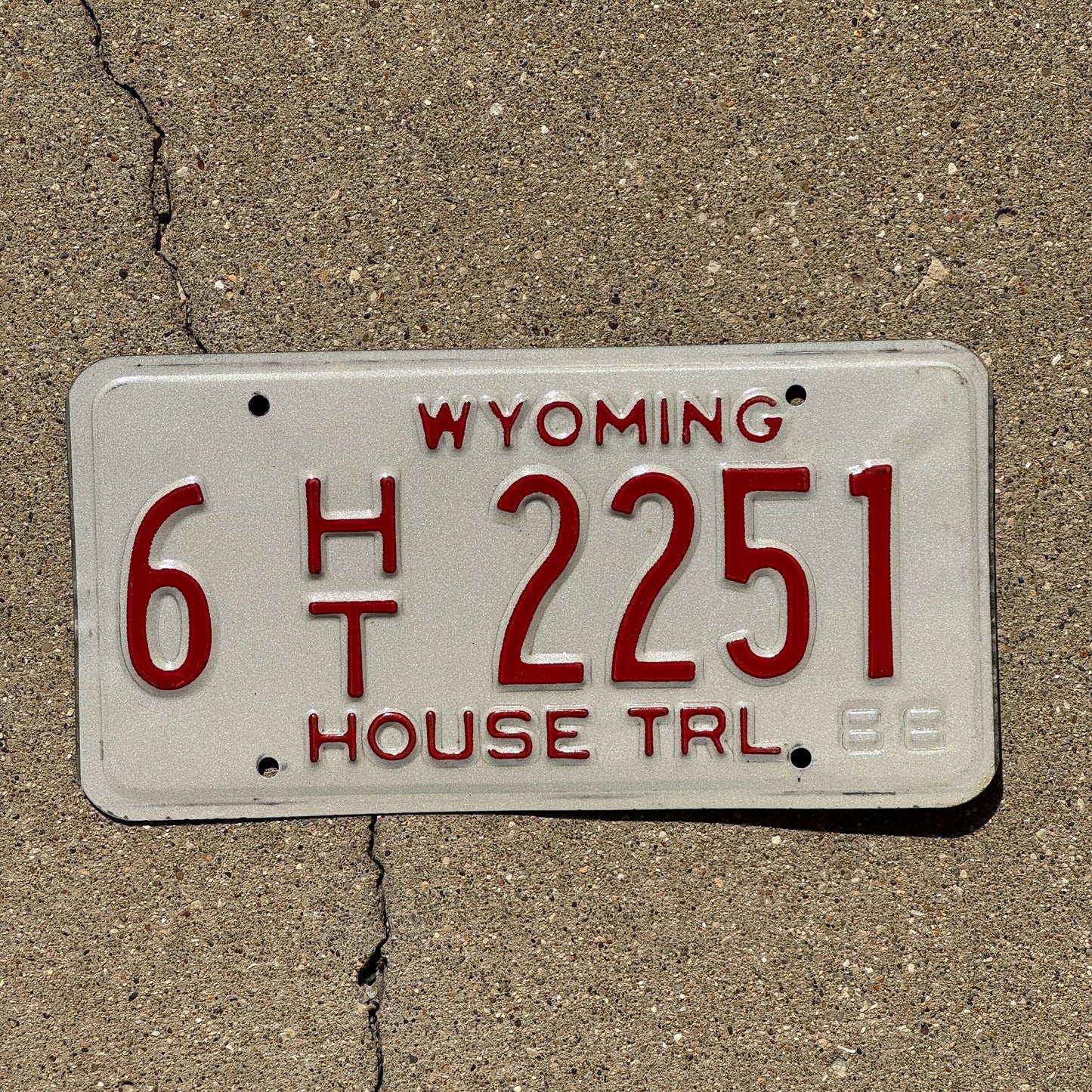 Photo of a 1989 Wyoming House Trailer License Plate Auto Tag Garage Decor Vintage 6 HT 2251