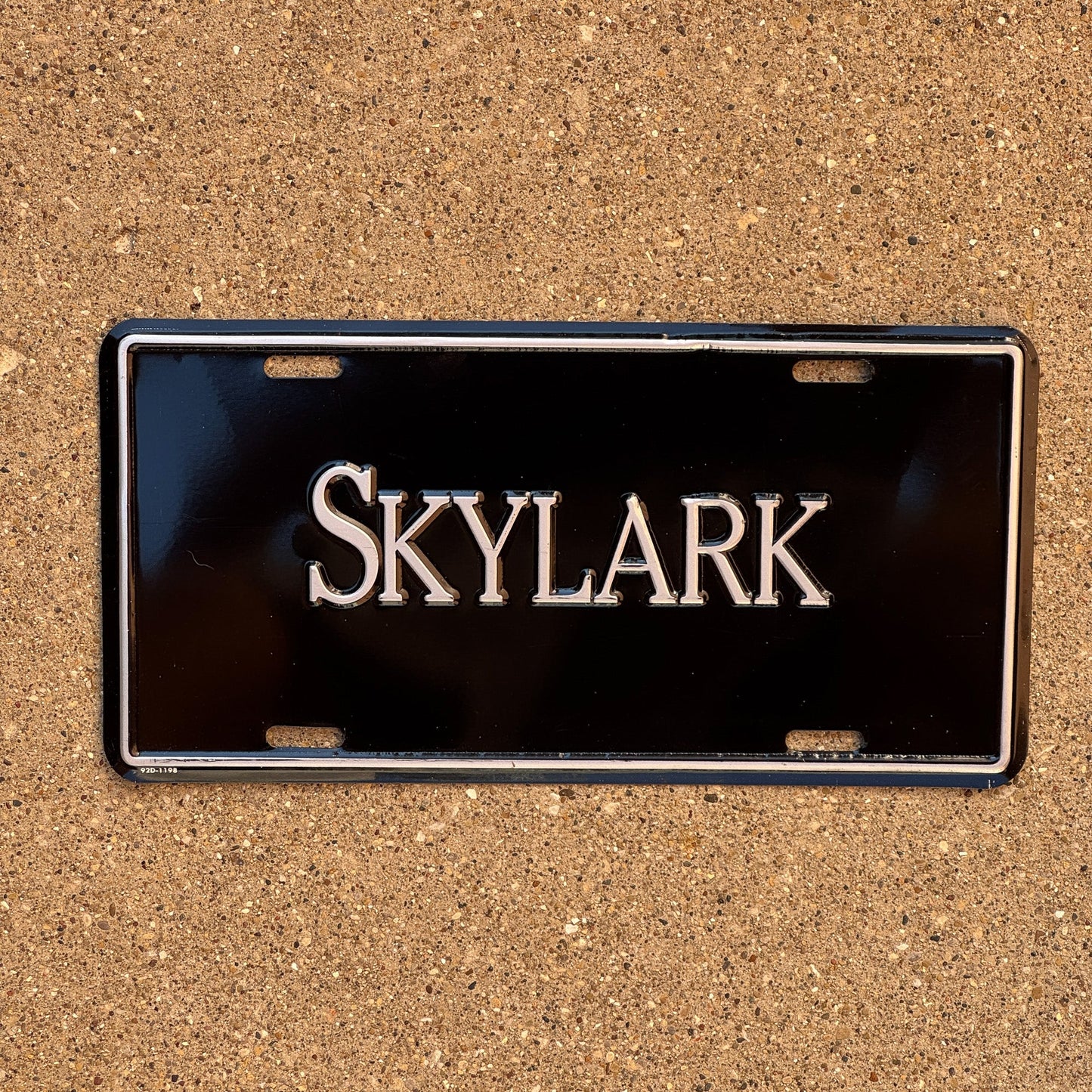 Photo of a 1990 Era Booster License Plate Auto Tag 2 Garage Decor Aluminum SKYLARK