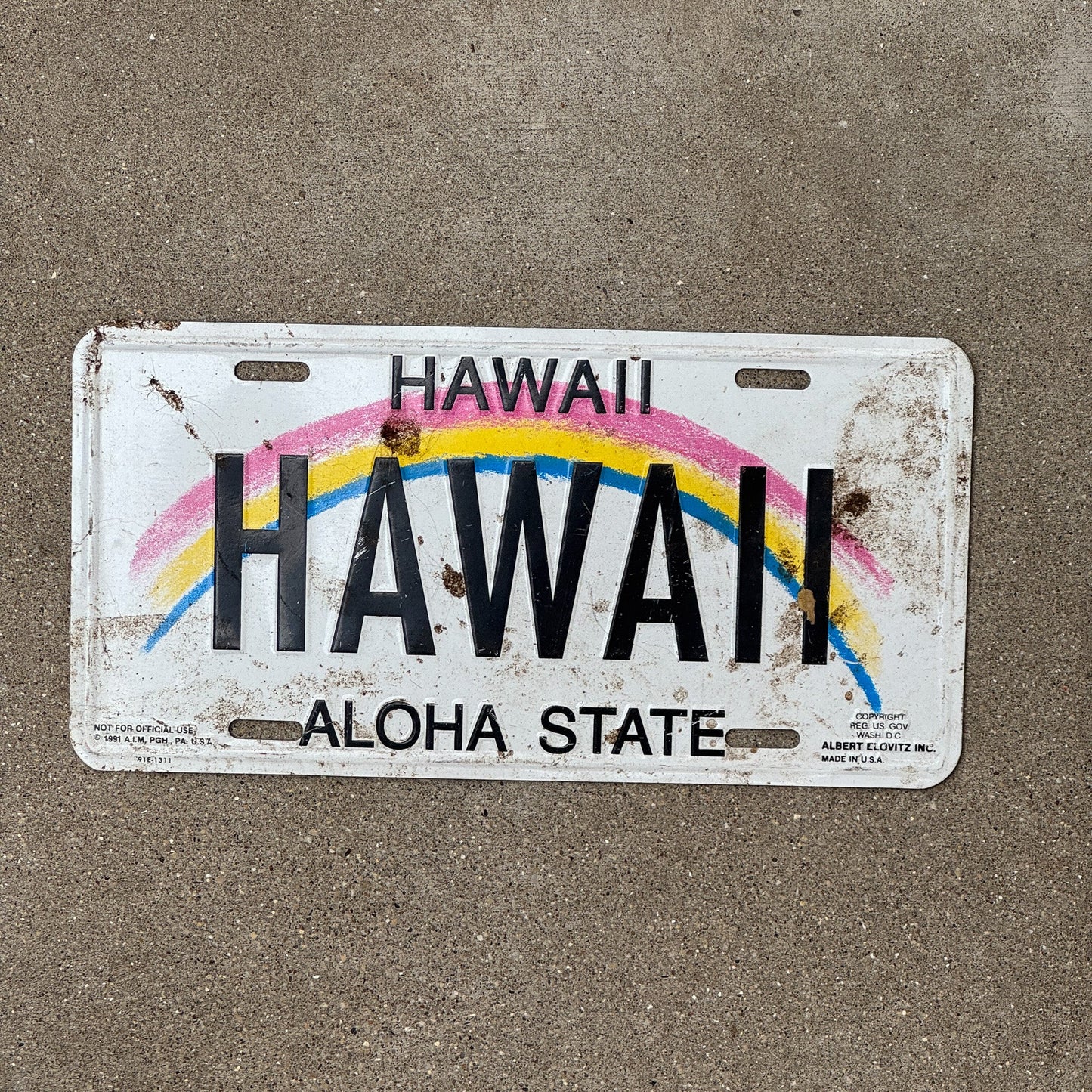 Photo of a 1990 Era Hawaii Booster License Plate Auto Tag Garage Decor Vintage Rainbow HAWAII