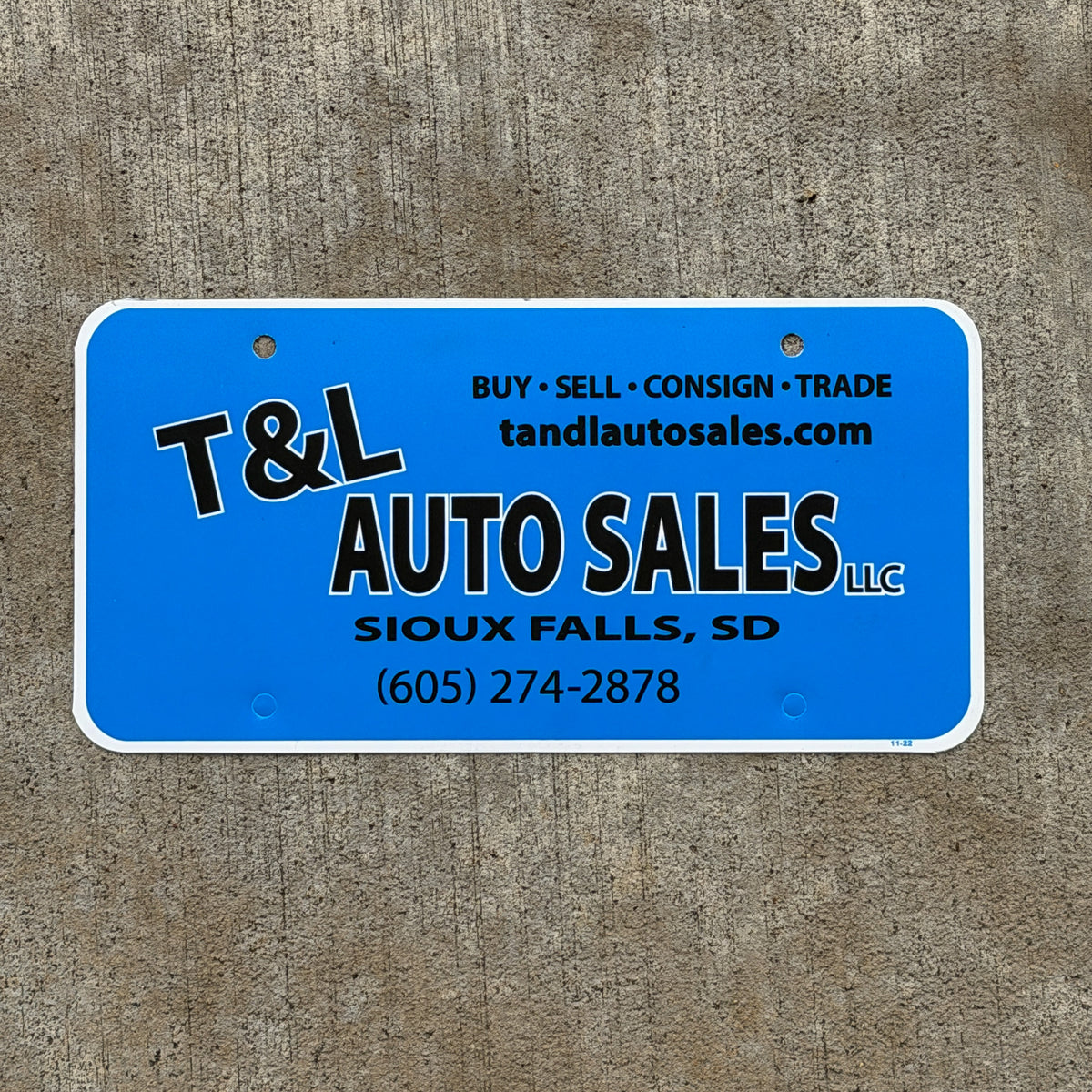 Photo of a 1990 Era Sioux Falls South Dakota Booster License Plate Auto Tag Garage Decor Vintage T & L Auto Sales Plastic with original patina
