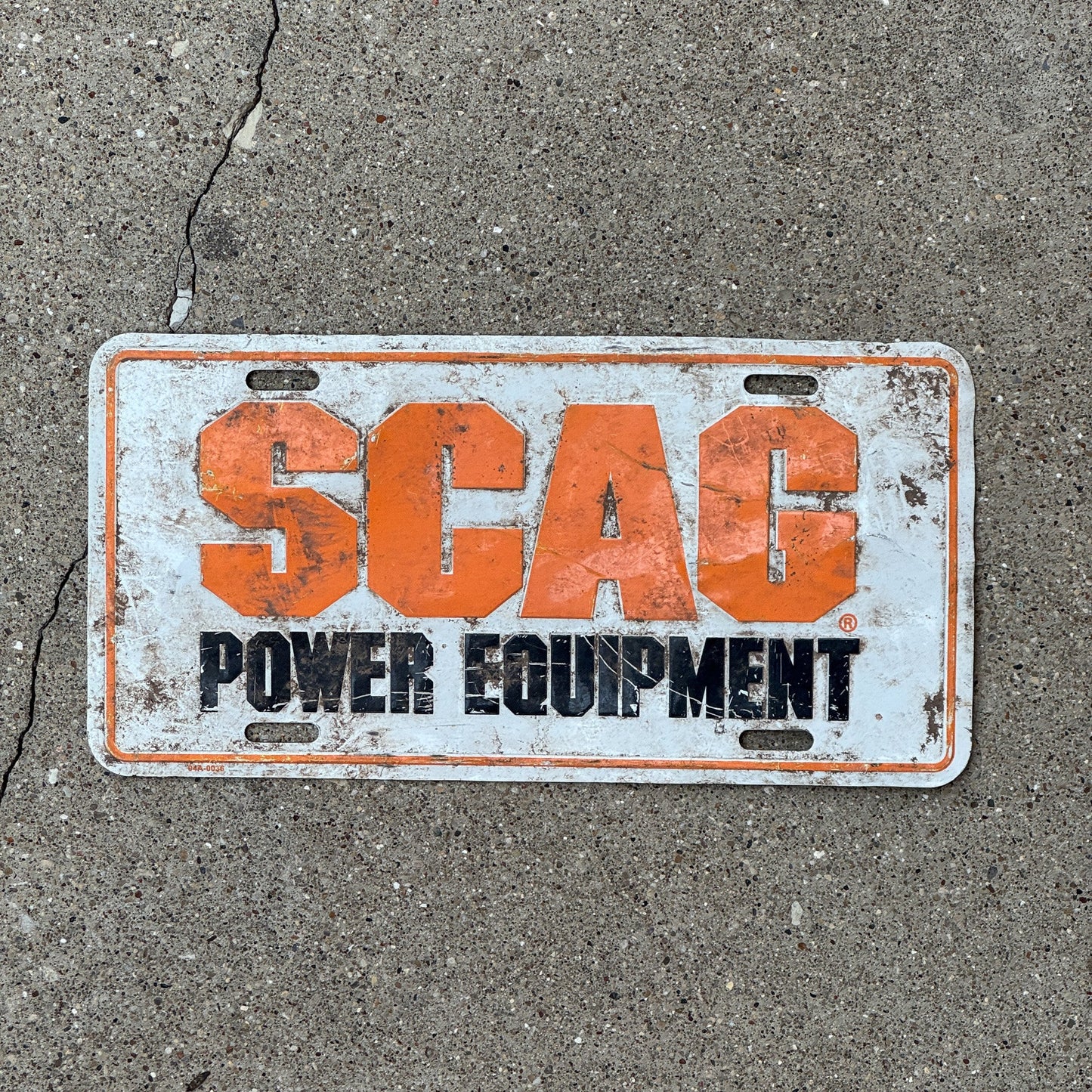 Photo of a 1990 Era Unnamed record Booster License Plate Auto Tag Garage Decor Vintage SCAG Power Equipment