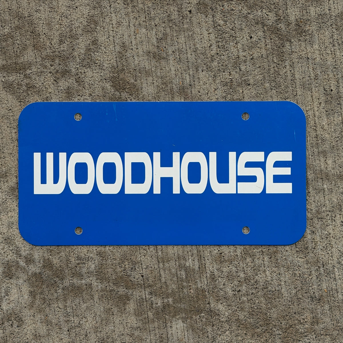 Photo of a 1990 Era Woodhouse Booster License Plate Auto Tag Garage Decor Vintage Plastic with original patina