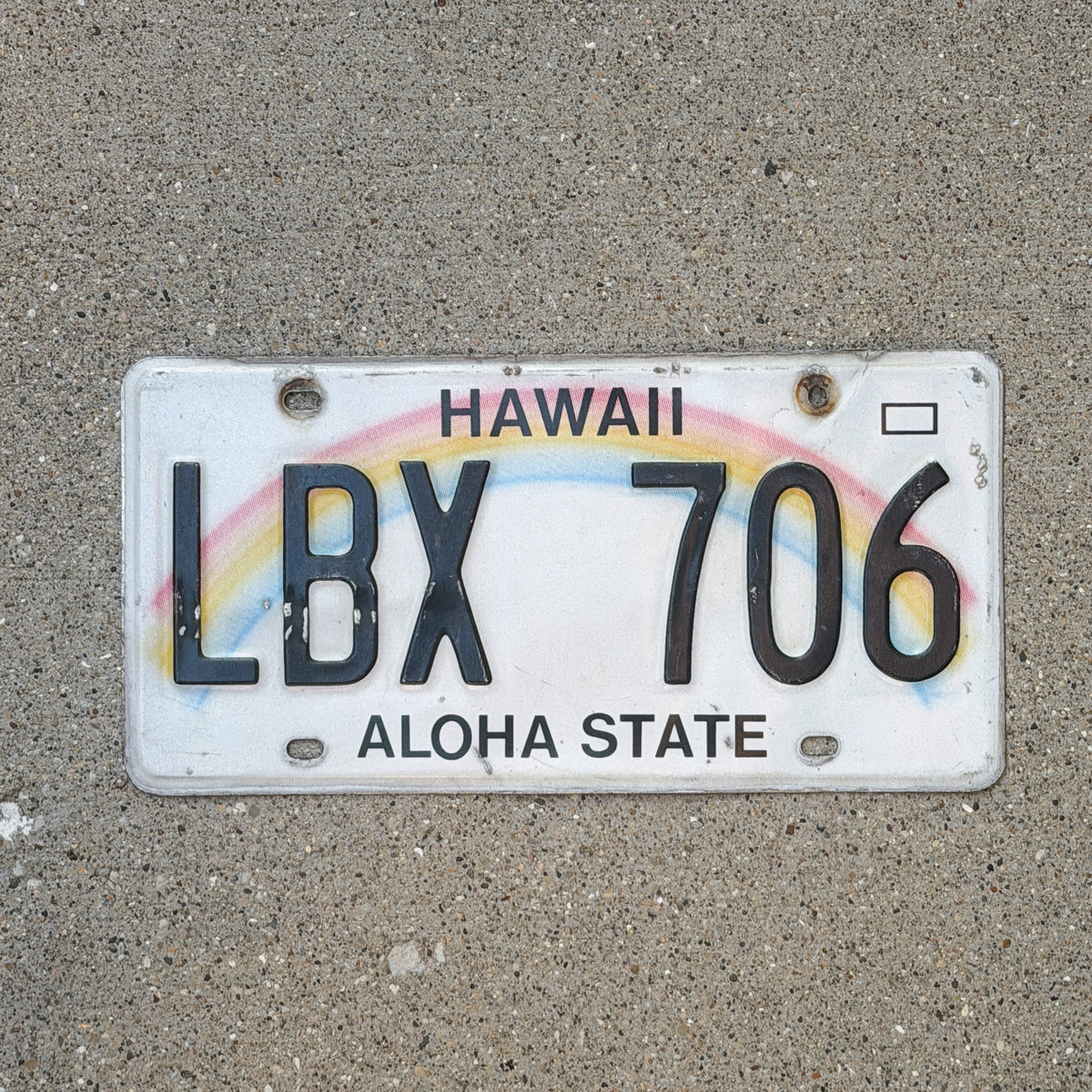 Photo of a 1990 Hawaii License Plate Auto Tag Garage Decor Vintage Rainbow LBX 706 with original patina