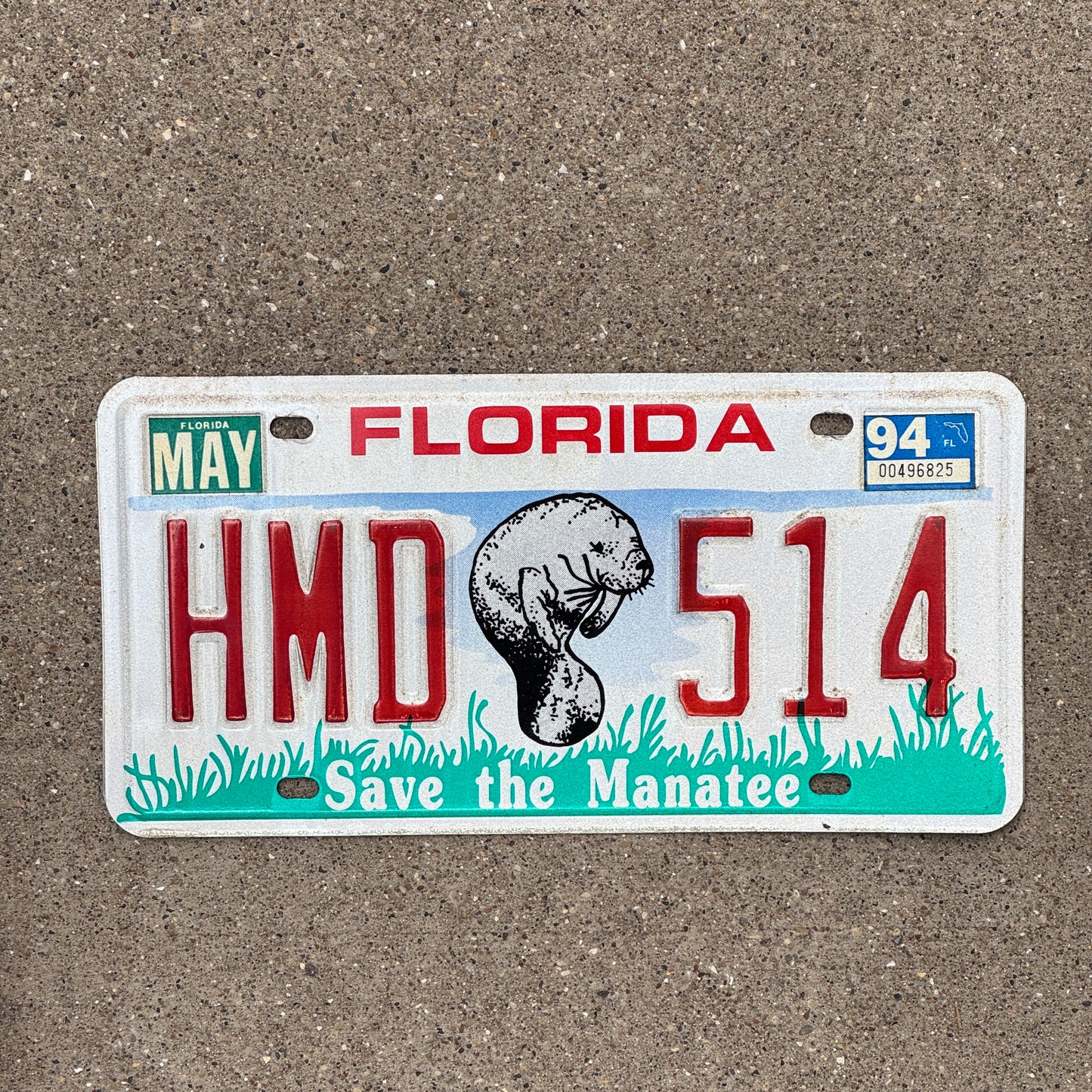 Photo of a 1990 Florida Graphic / Specialty License Plate Auto Tag with Manatee Base, HMD 514, and 1994 registration sticker