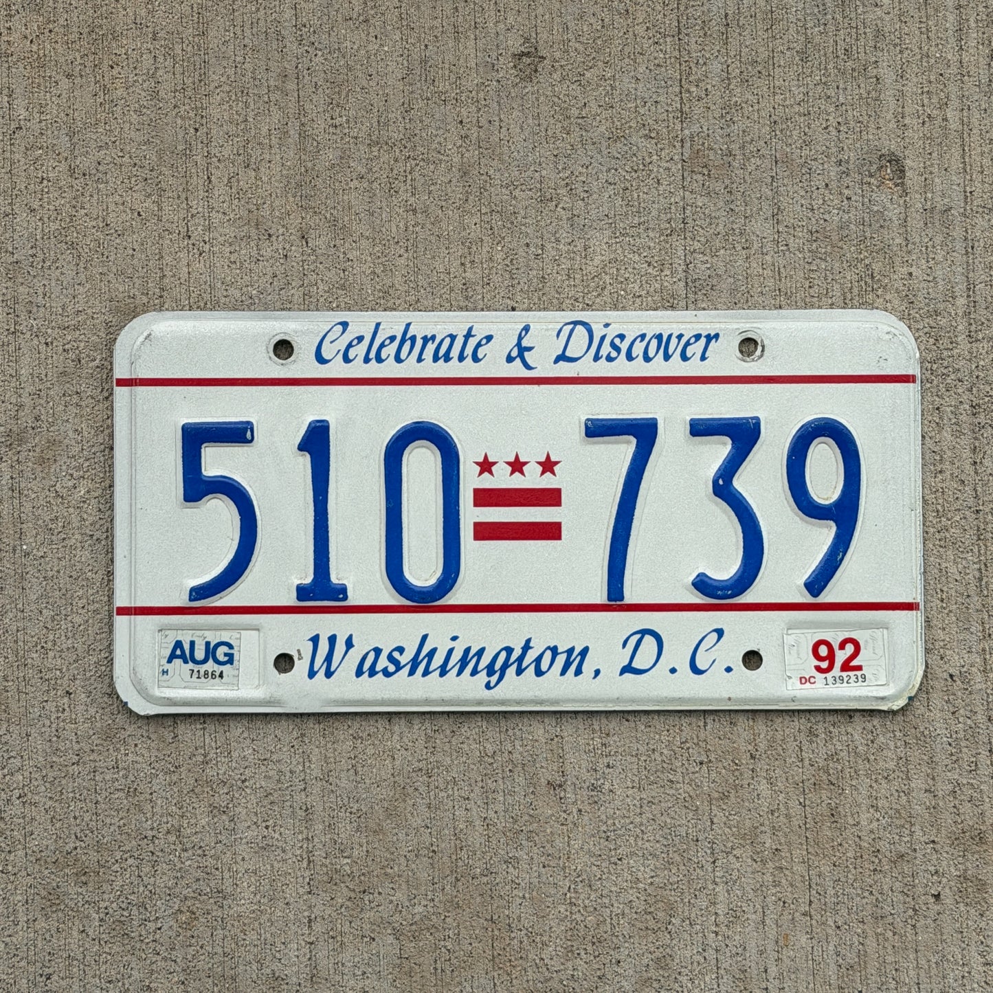 Photo of a 1991 1992 Washington DC License Plate Auto Tag Garage Decor Vintage Celebrate and Discover 510 739 with original patina