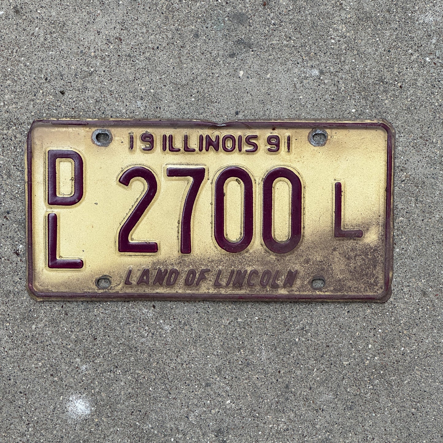 Photo of a 1991 Illinois Dealer License Plate Auto Tag Garage Decor Vintage 2700 L with original patina